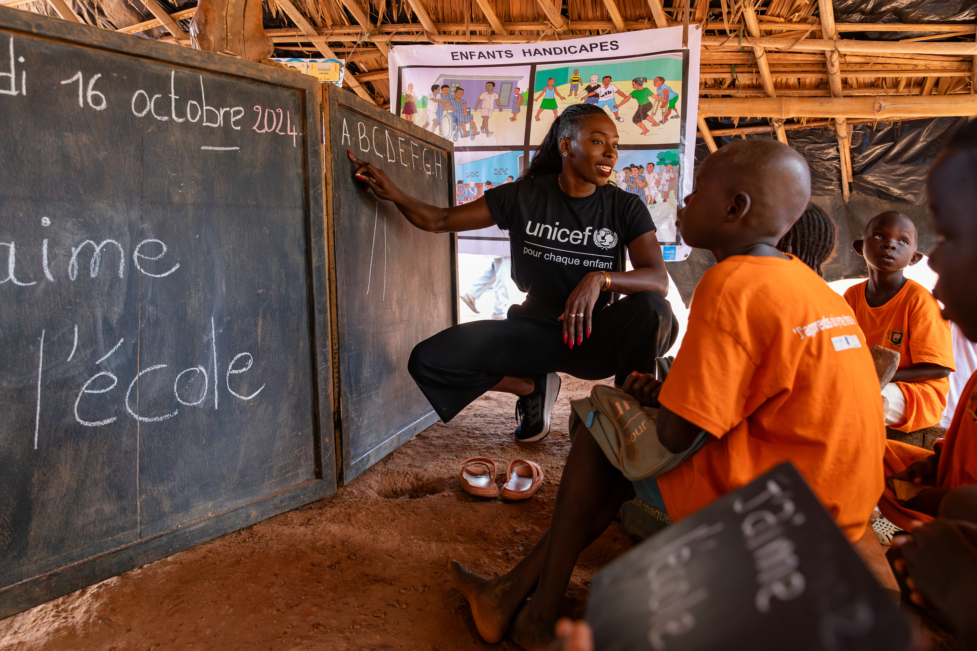 On October 16, 2024, UNICEF Ambassador Murielle Ahouré Demps leads a reading lesson in an itinerant teaching class in Rémikro, near Méagui, South-West Côte d’Ivoire. This UNICEF-supported initiative brings education directly to remote communities in West Africa, offering children the chance to learn within their own environment. Captured by Miléquêm Diarassouba, Photojournalist West Africa.