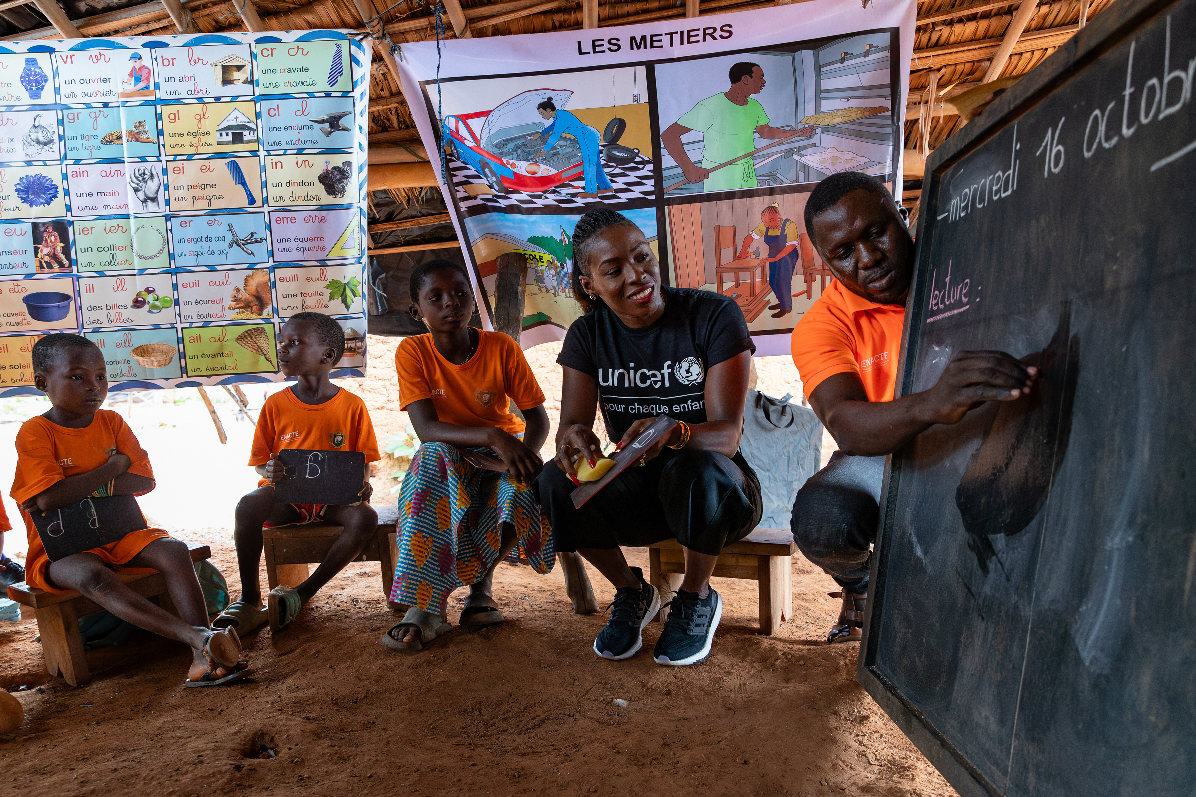 On 16th October 2024, UNICEF Ambassador Murielle Ahouré Demps participates in an itinerant teaching class in Rémikro, a village near Méagui, South-West Côte d’Ivoire. This initiative allows children to learn directly in their camp thanks to the mobile nature of the itinerant teaching program. Captured by Miléquêm Diarassouba, Photojournalist West Africa.