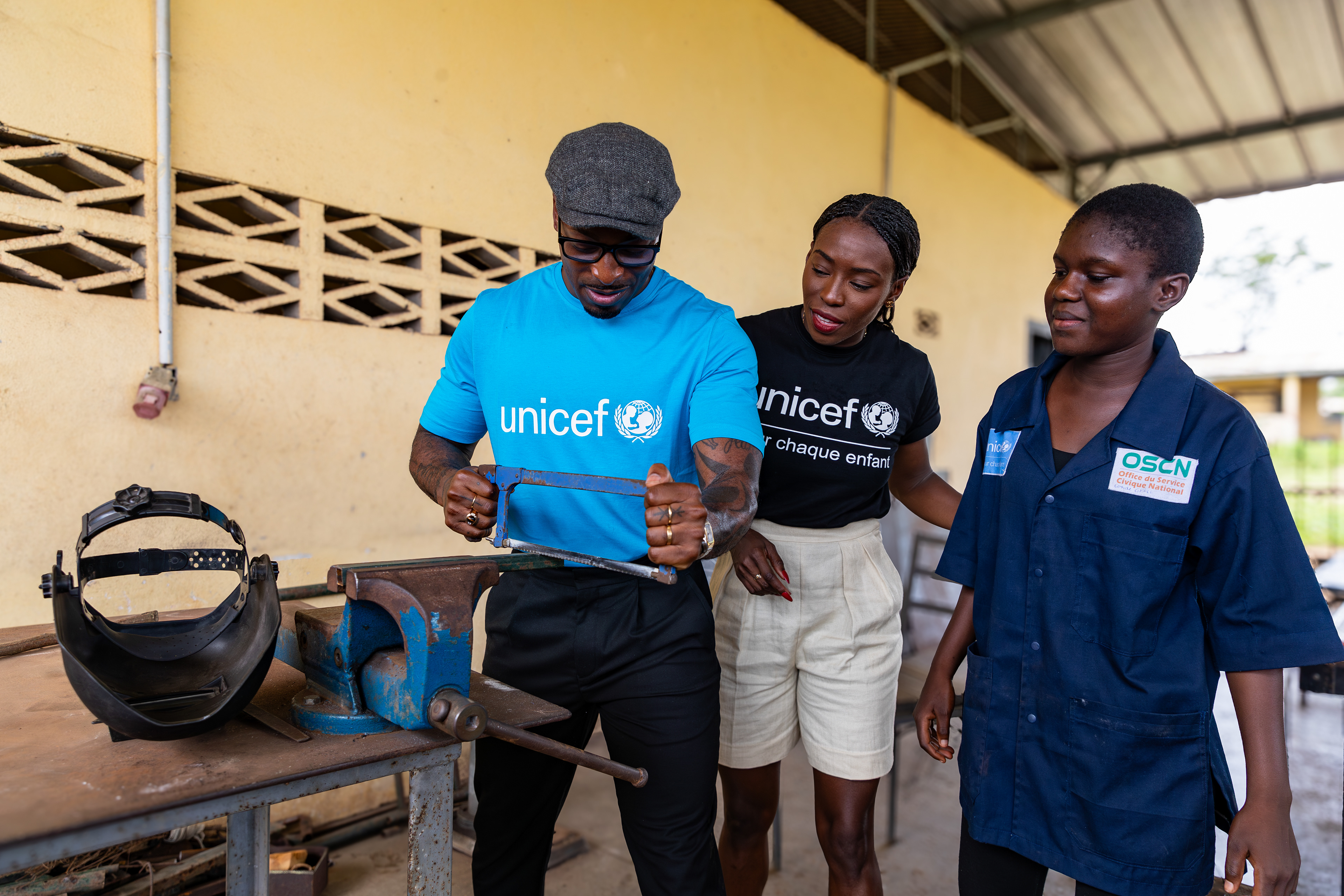 On 15th October 2024, at the Centre Civique d’Action pour le Développement in Guédikpo, South-West Côte d’Ivoire, Jeff Demps saws during a blacksmithing class under the watchful eye of his wife, UNICEF Ambassador Murielle Ahouré Demps, as part of her visit. Captured by Miléquêm Diarassouba, Photojournalist West Africa.