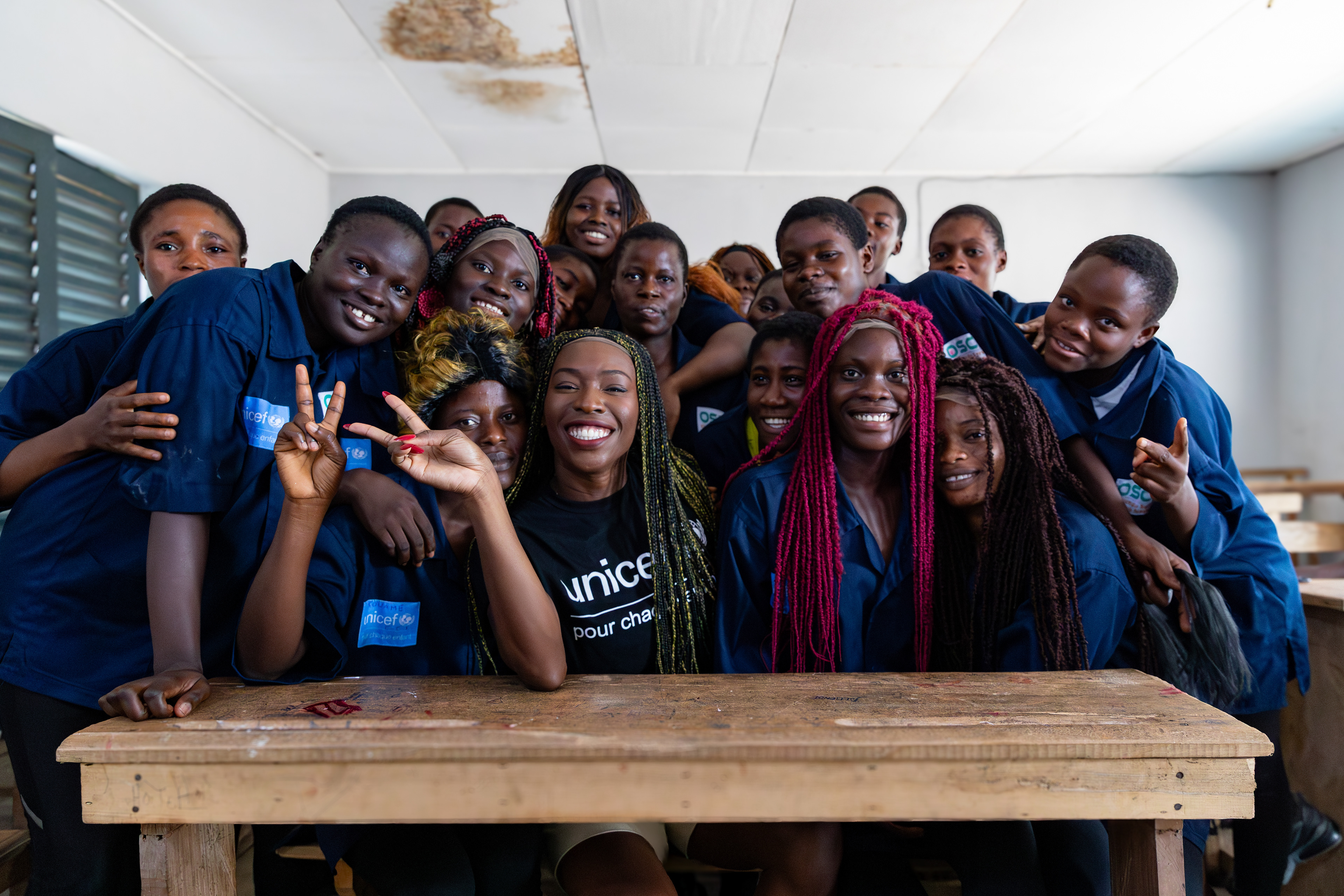 On 15th October 2024, at the Centre Civique d’Action pour le Développement in Guédikpo, South-West Côte d’Ivoire, UNICEF Ambassador Murielle Ahouré Demps poses with the girls from the hairdressing class, proudly wearing one of the wigs they made as part of the Girl Power project. Captured by Miléquêm Diarassouba, Photojournalist West Africa.