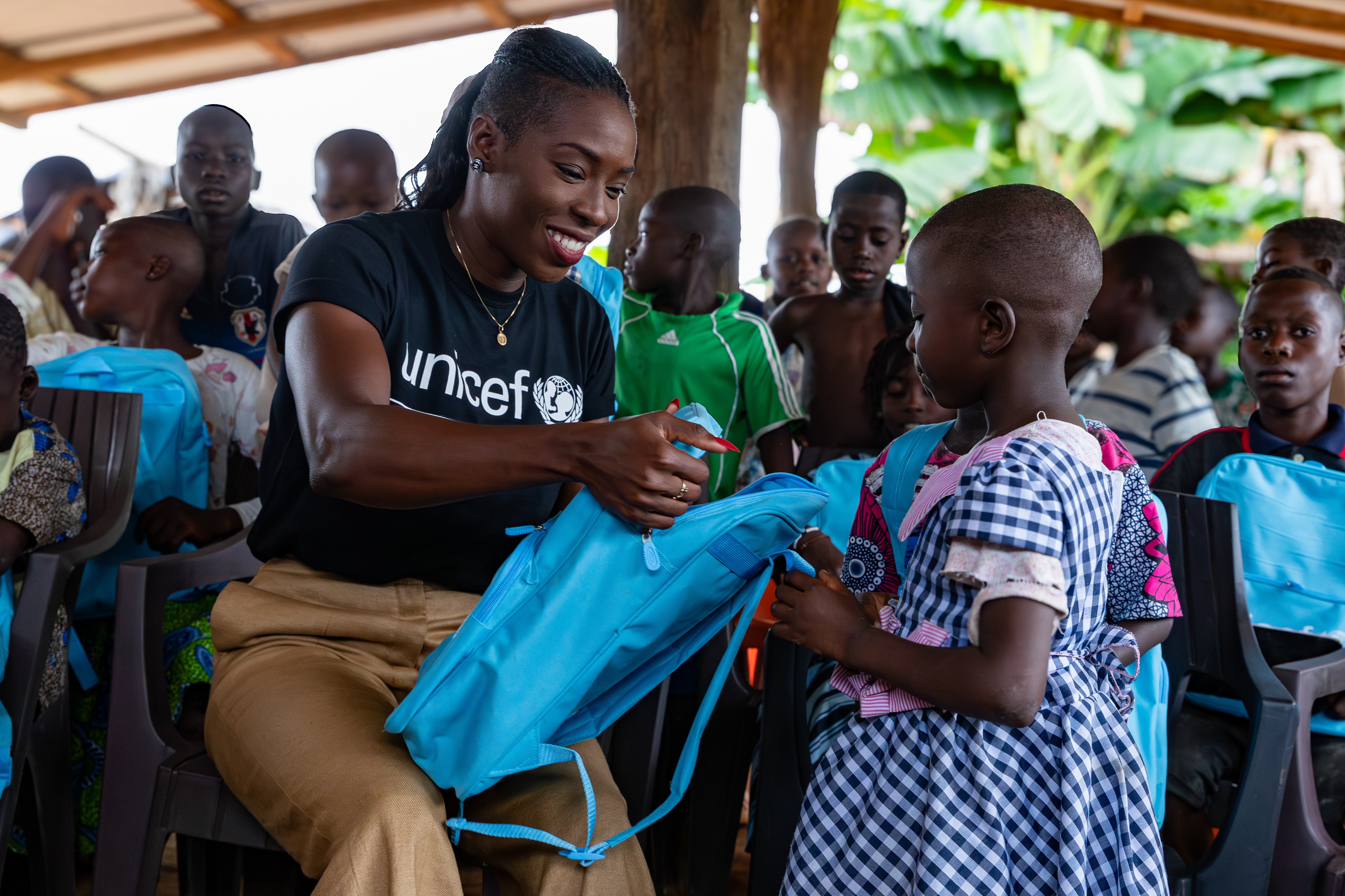 On 17th October 2024, UNICEF Ambassador Murielle Ahouré Demps distributes school kits to eager students in the itinerant teaching class in Felixkro, South-West Côte d’Ivoire. Captured by Miléquêm Diarassouba, Photojournalist West Africa.