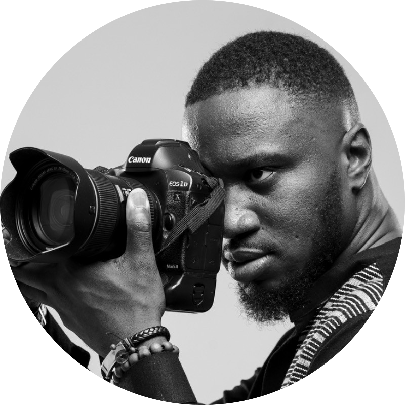 Miléquêm Diarassouba - Renowned photojournalist and filmmaker in Côte d’Ivoire, holding a professional Canon camera, specializing in capturing everyday life, human experiences, and storytelling through photography and film in West Africa.