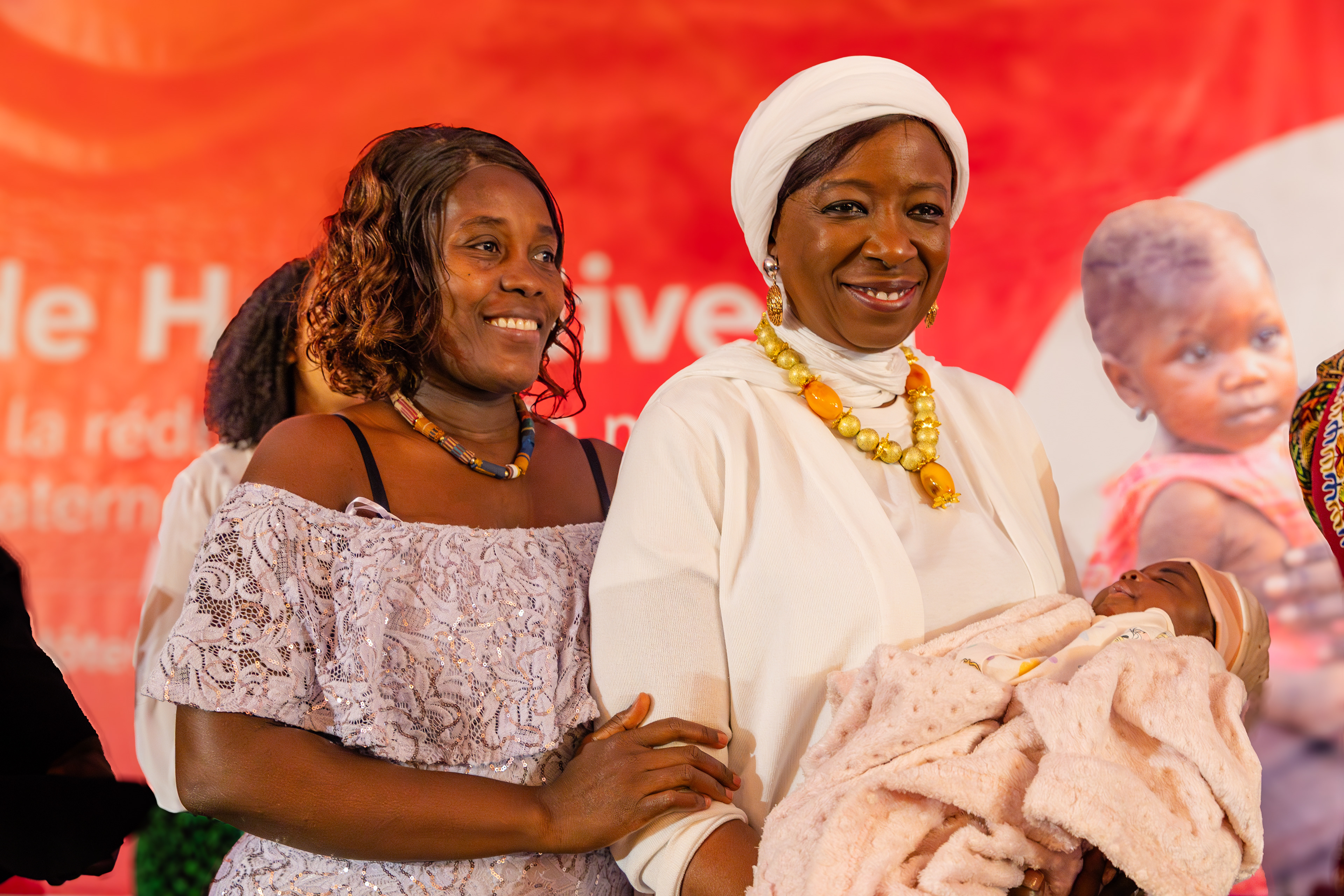 UNFPA Executive Director, Dr. Diene Keita, holds baby Exaucée, daughter of Loukou Amon Blandine, during the high-level dialogue held on 11 September 2025 in Abidjan. The image symbolized the continuity between testimony, care, and UNFPA’s commitment to ensuring that every birth is safe and every child welcomed with dignity.