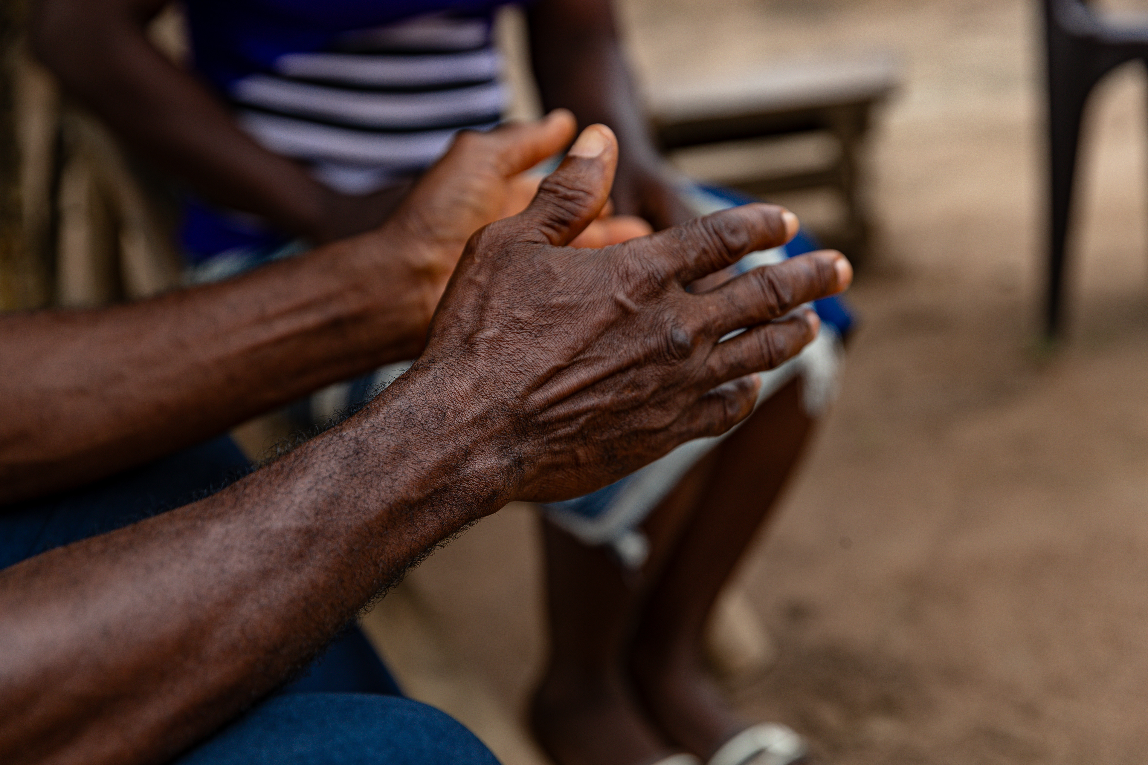 Digbeu Zeze Sylvain, a DREAMS Godfather, came to talk to a woman who called on him to resolve a conflict in the village of Zokoguhé, 18 km from Daloa in western Côte d'Ivoire, on 29 June 2024.