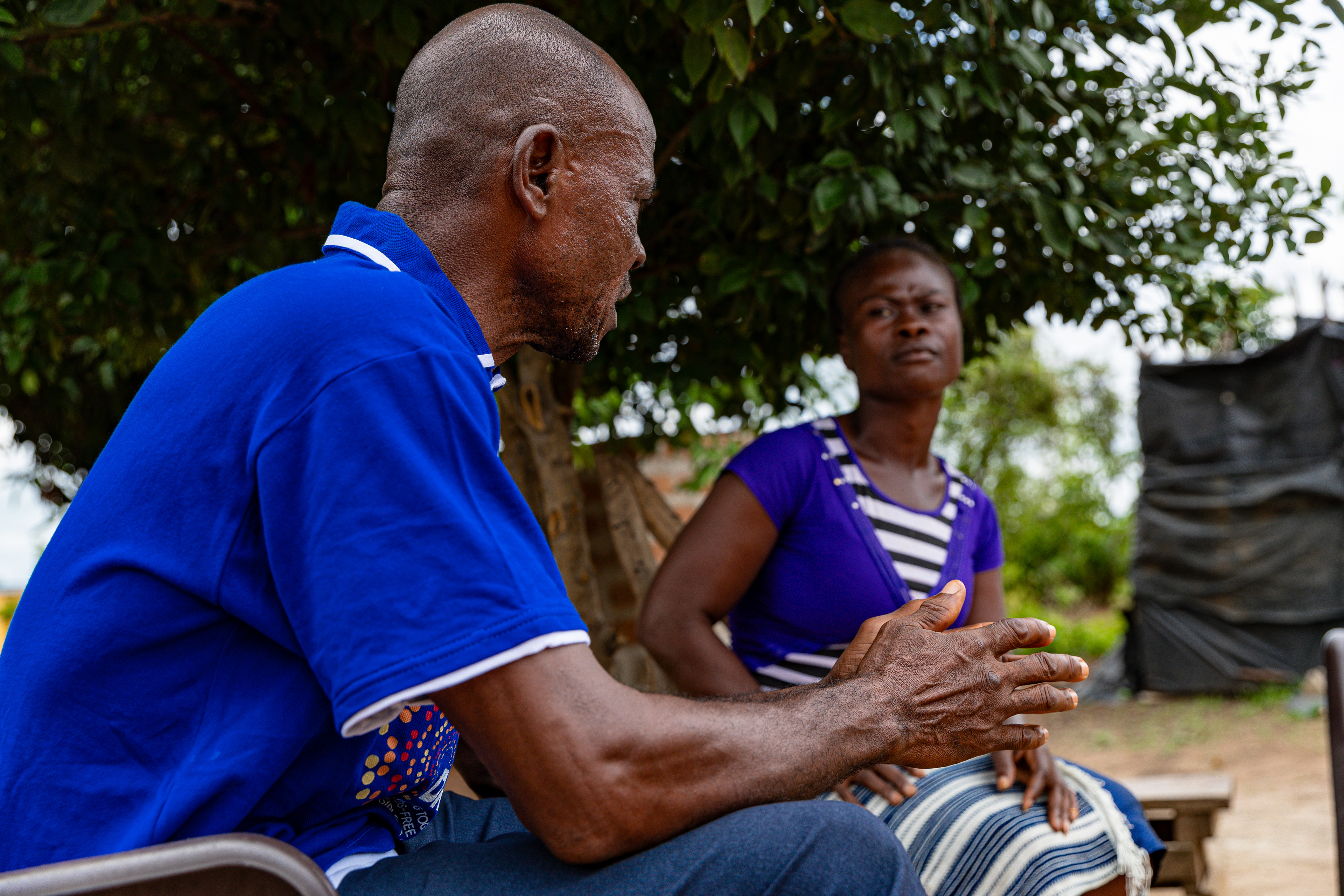 Digbeu Zeze Sylvain, a DREAMS Godfather, came to talk to a woman who called on him to resolve a conflict in the village of Zokoguhé, 18 km from Daloa in western Côte d'Ivoire, on 29 June 2024.