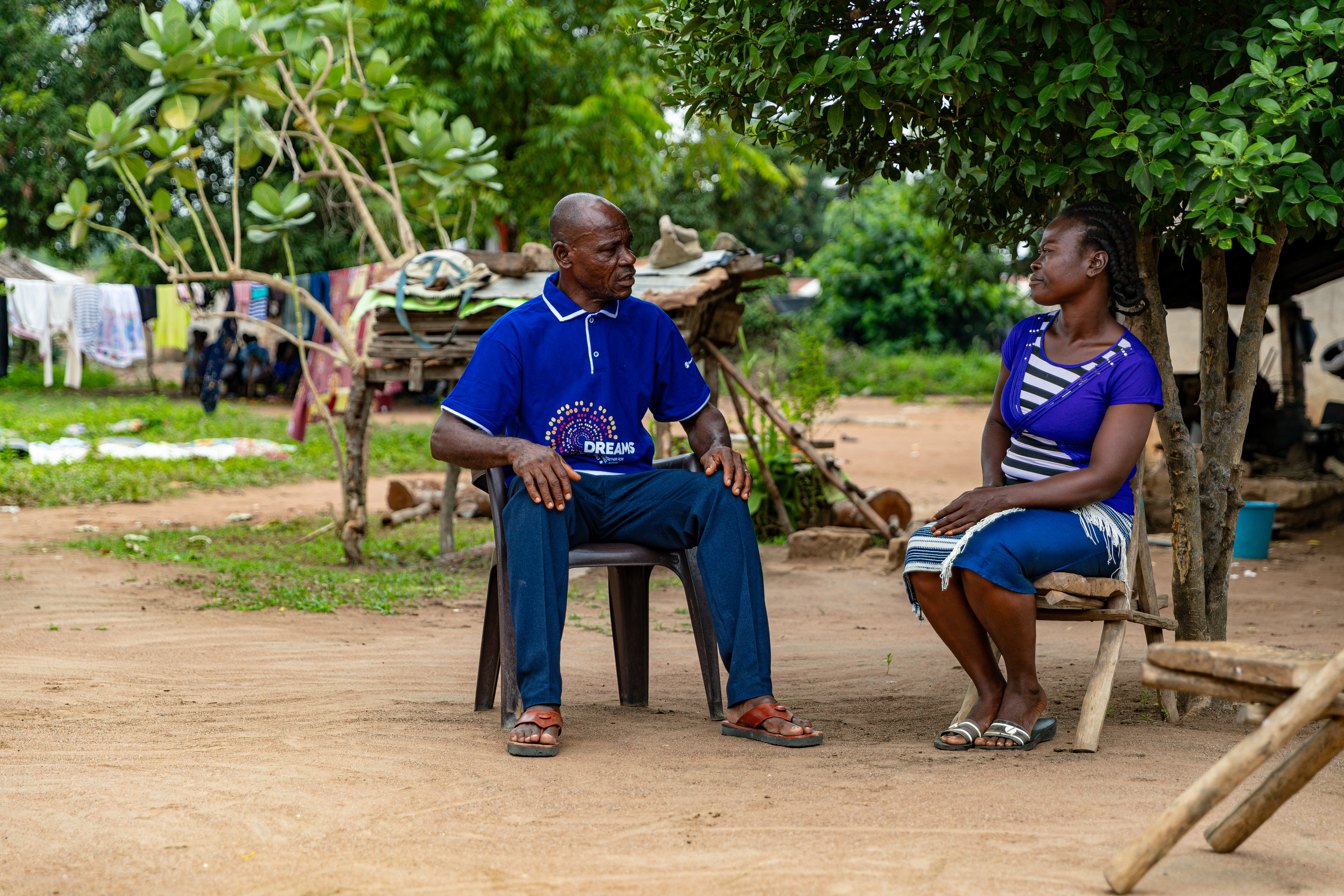 Digbeu Zeze Sylvain, a DREAMS Godfather, came to talk to a woman who called on him to resolve a conflict in the village of Zokoguhé, 18 km from Daloa in western Côte d'Ivoire, on 29 June 2024.