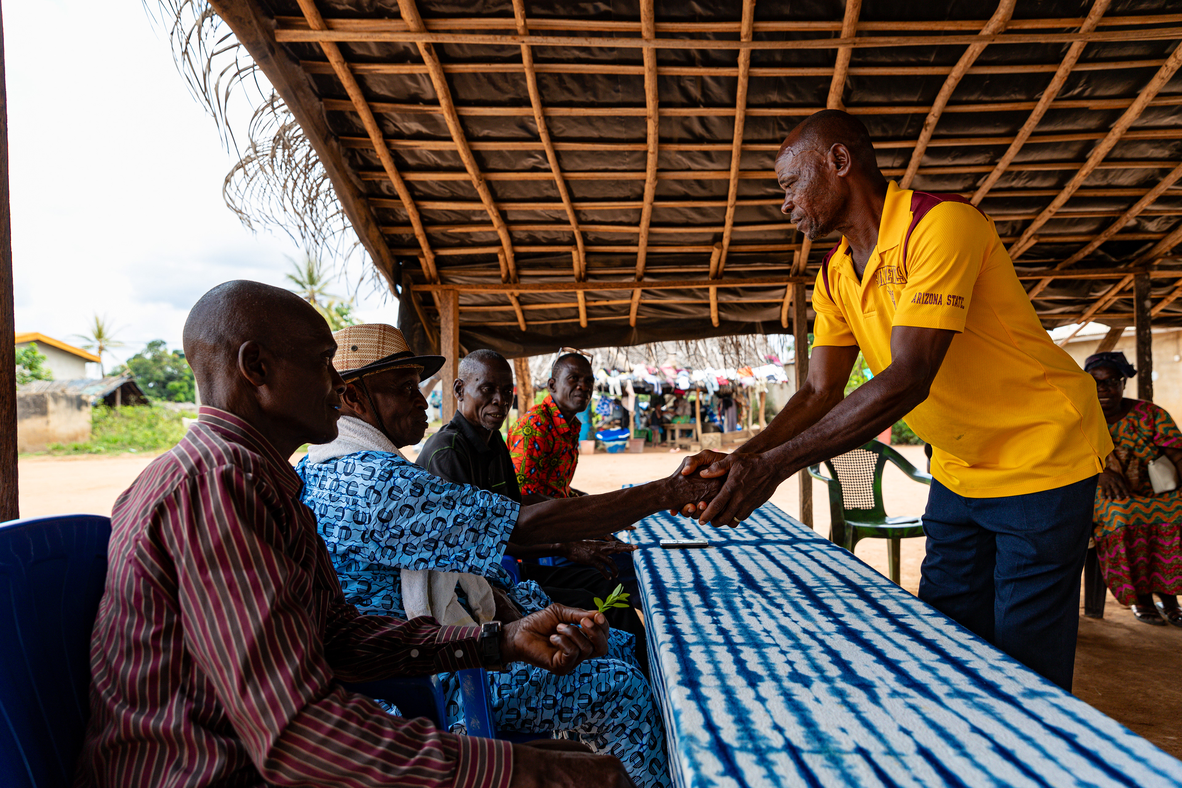 Digbeu Zeze Sylvain, advisor to Ziza Boli Jean Jacques, village chief, attends a meeting in Zokoguhé, a village 18 km from Daloa in western Côte d'Ivoire, on 29 June 2024.