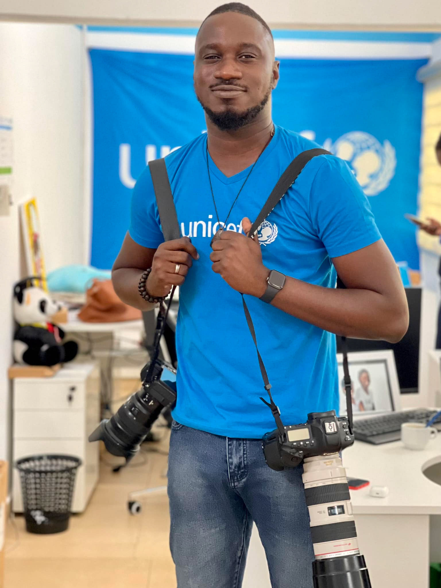 Miléquêm Diarassouba, Photojournalist West Africa, with cameras at UNICEF Côte d'Ivoire Communication Office in Abidjan, 13 October 2022, for human interest storytelling.
