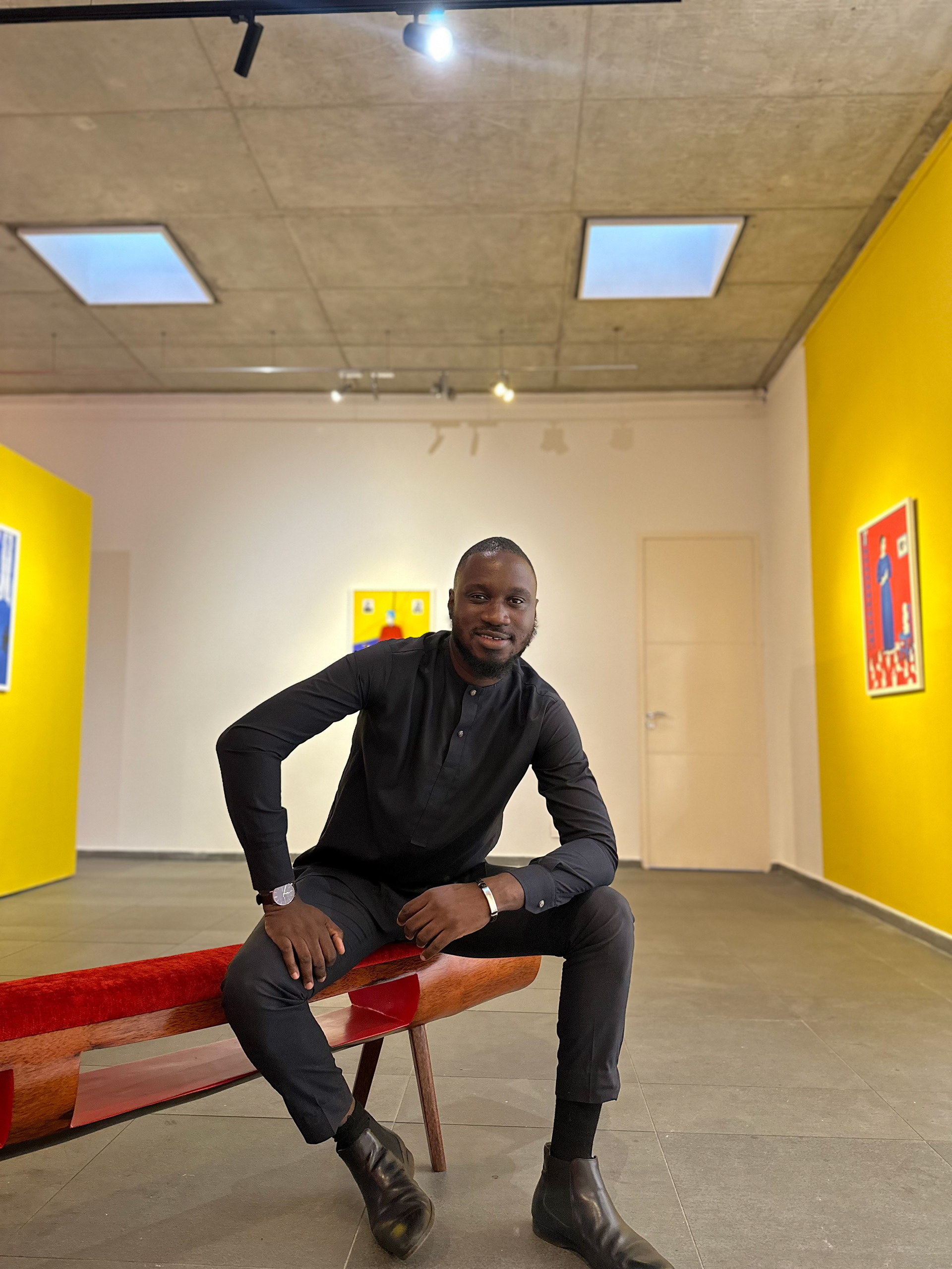 Miléquêm Diarassouba, Photojournalist West Africa, sitting in Aïda Muluneh exhibition at LouiSimone Guirandou Gallery, Abidjan, Côte d'Ivoire, 12 September 2024.