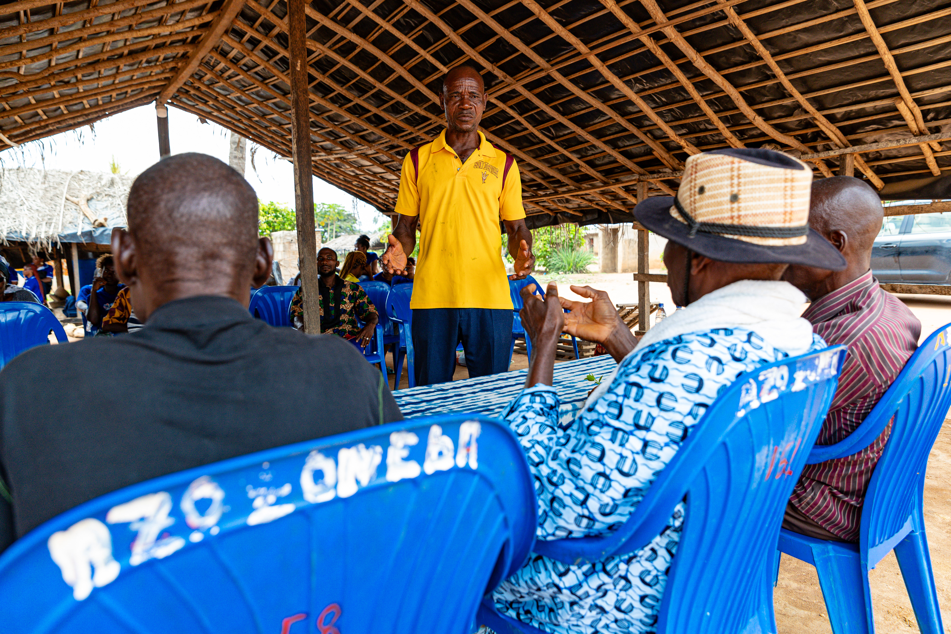 Digbeu Zeze Sylvain, advisor to Ziza Boli Jean Jacques, village chief, attends a meeting in Zokoguhé, a village 18 km from Daloa in western Côte d'Ivoire, on 29 June 2024.