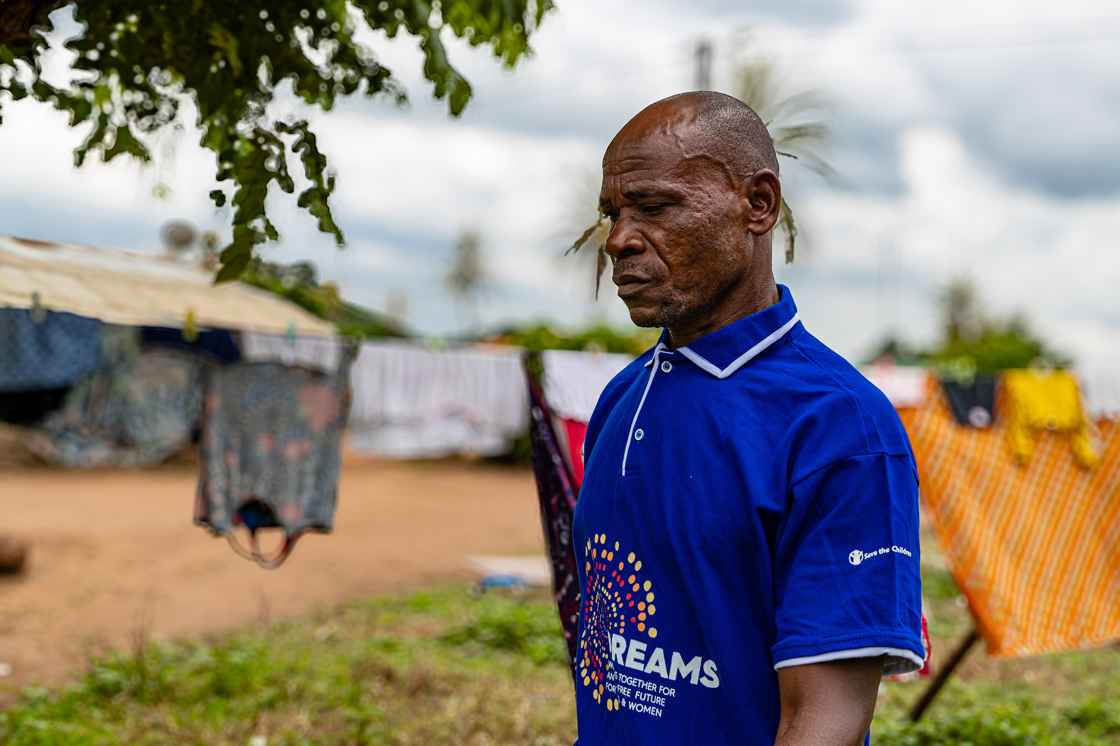 Digbeu Zeze Sylvain, a DREAMS Godfather, walks towards a woman who called on him to resolve a conflict in her village of Zokoguhé, 18 km from Daloa in western Côte d'Ivoire, on 29 June 2024.