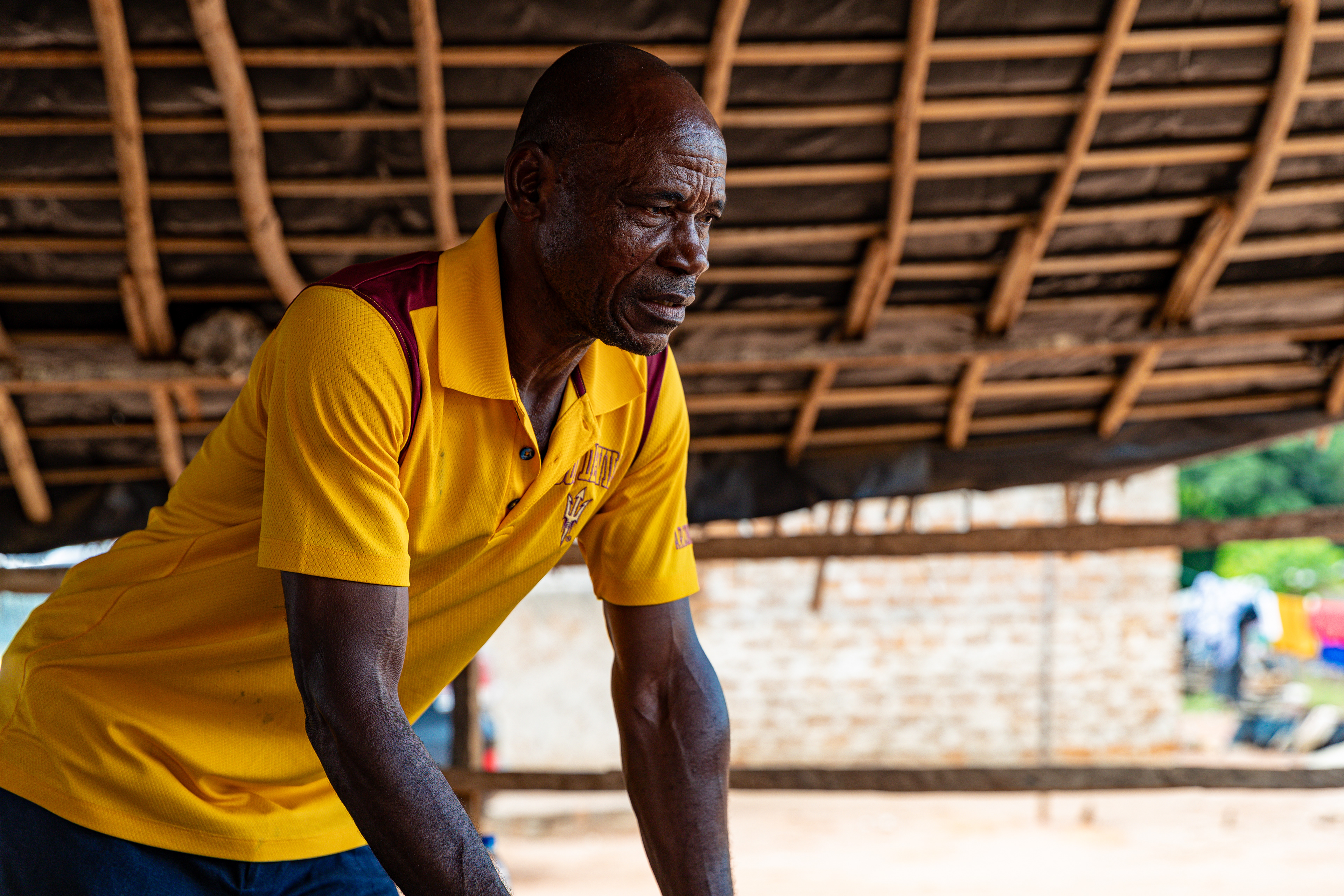 Digbeu Zeze Sylvain, advisor to Ziza Boli Jean Jacques, village chief, attends a meeting in Zokoguhé, a village 18 km from Daloa in western Côte d'Ivoire, on 29 June 2024.