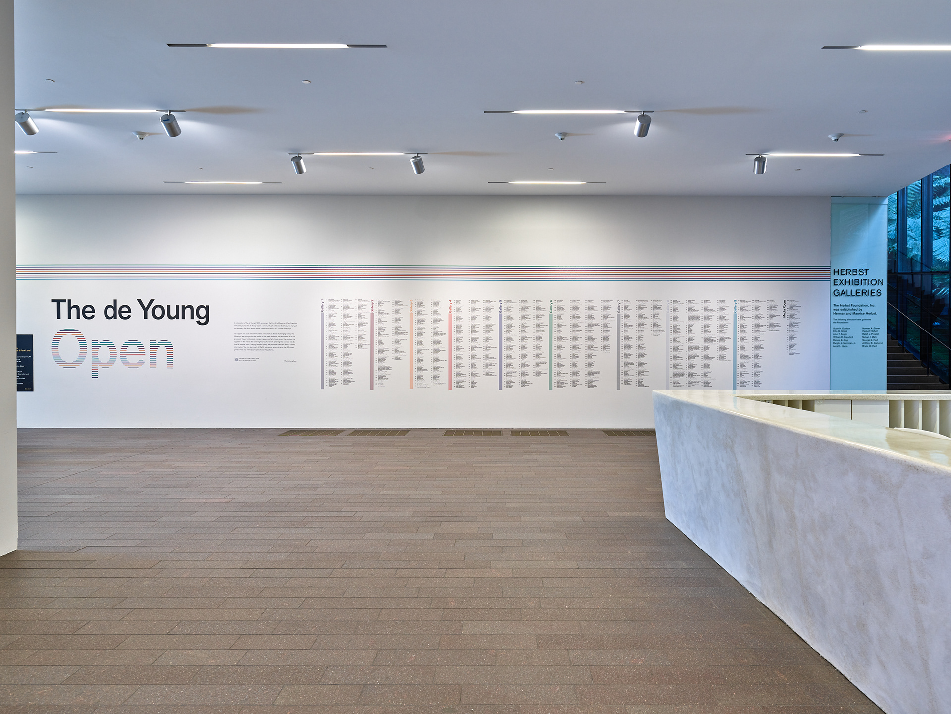 Installed title wall integrating exhibition identity, introductory text, and artist directory.