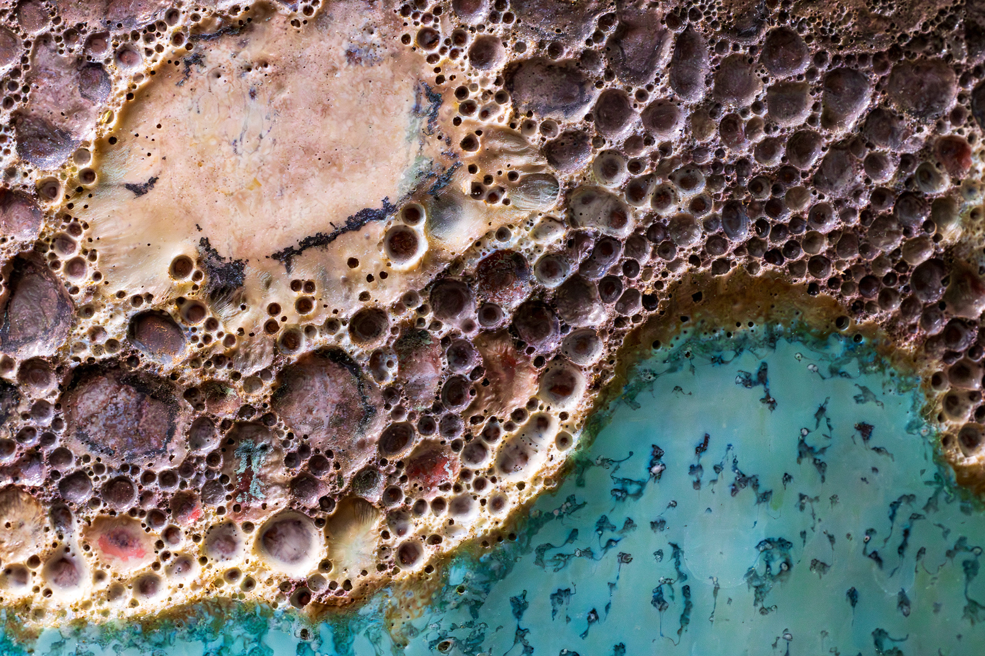 Abstract macro photography of oxidized copper patina showing teal verdigris and orange rust textures that look like an aerial tropical coastline.Abstract macro photography of oxidized copper patina showing teal verdigris and orange rust textures that look like an aerial tropical coastline.