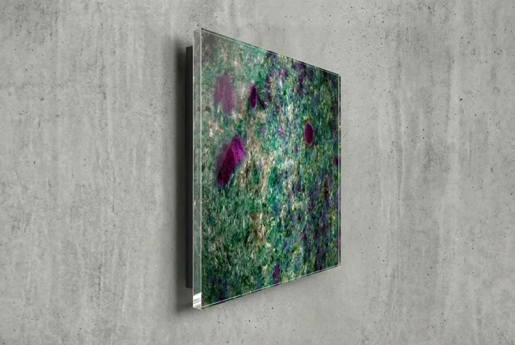 Side angle view of a floating Acrylic Face Mount print on a concrete wall, showing the hidden inset frame that creates a shadow gap and 3D depth.