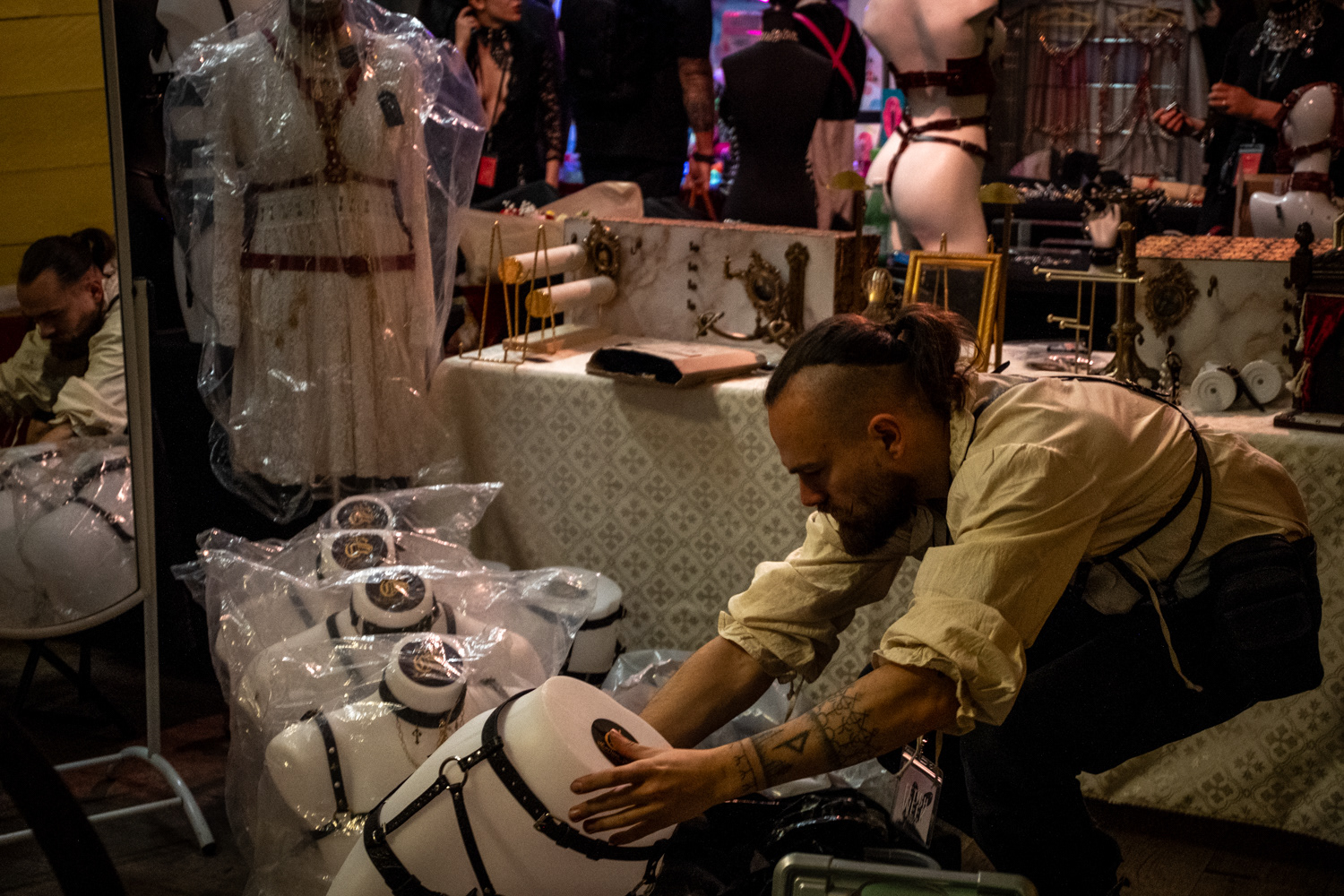 Olivier, the founder of “Corium Sancti” brand, working at his booth during Paris Fetish Week on November 25, 2024.