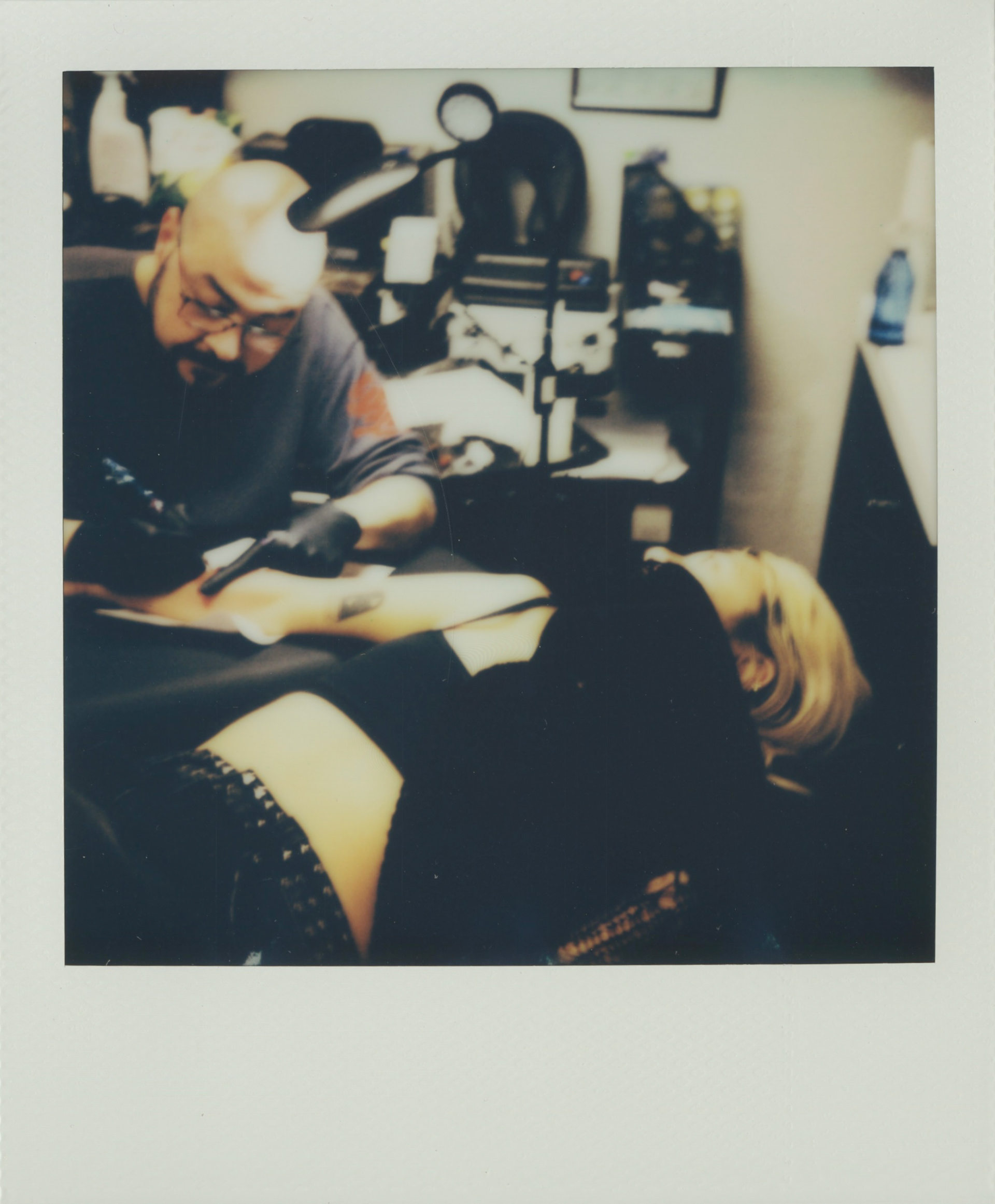 cat getting her Sundays tattoo in all red ink