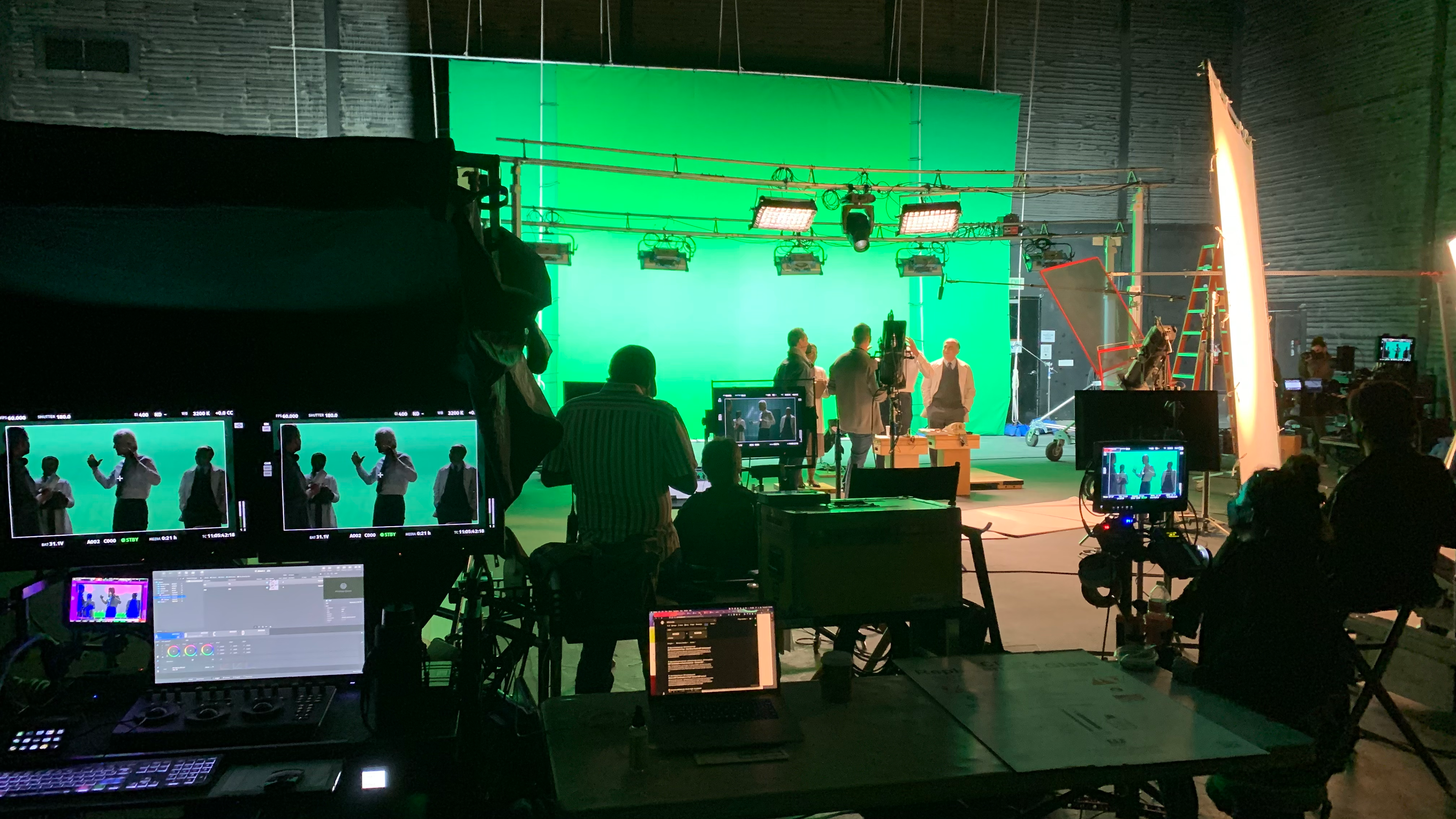 Crew at monitors and cameras in front of a green screen during filming of the Stranger Things Immersive Experience
