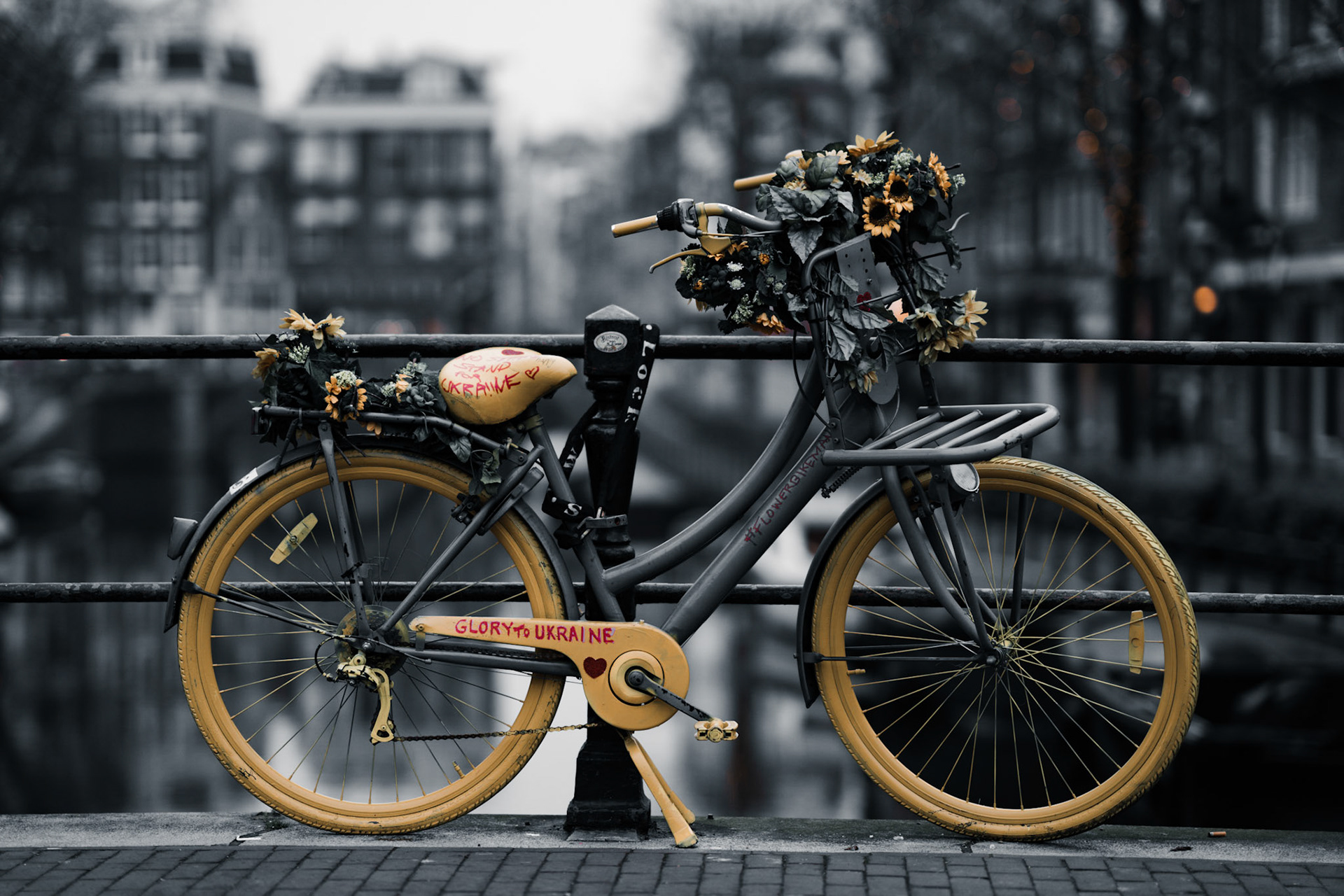 A colorful bicycle on a canal bridge in Amsterdam in support for Ukraine.