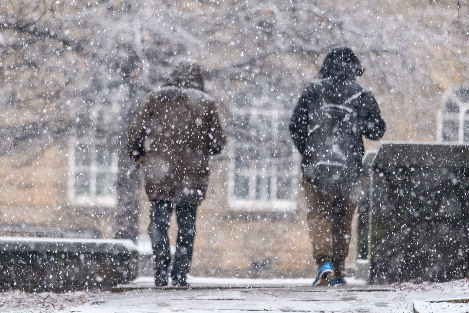 Lockdown3- Two homeless people walking in the snow outside the Cathedral Archer Project, Sheffield