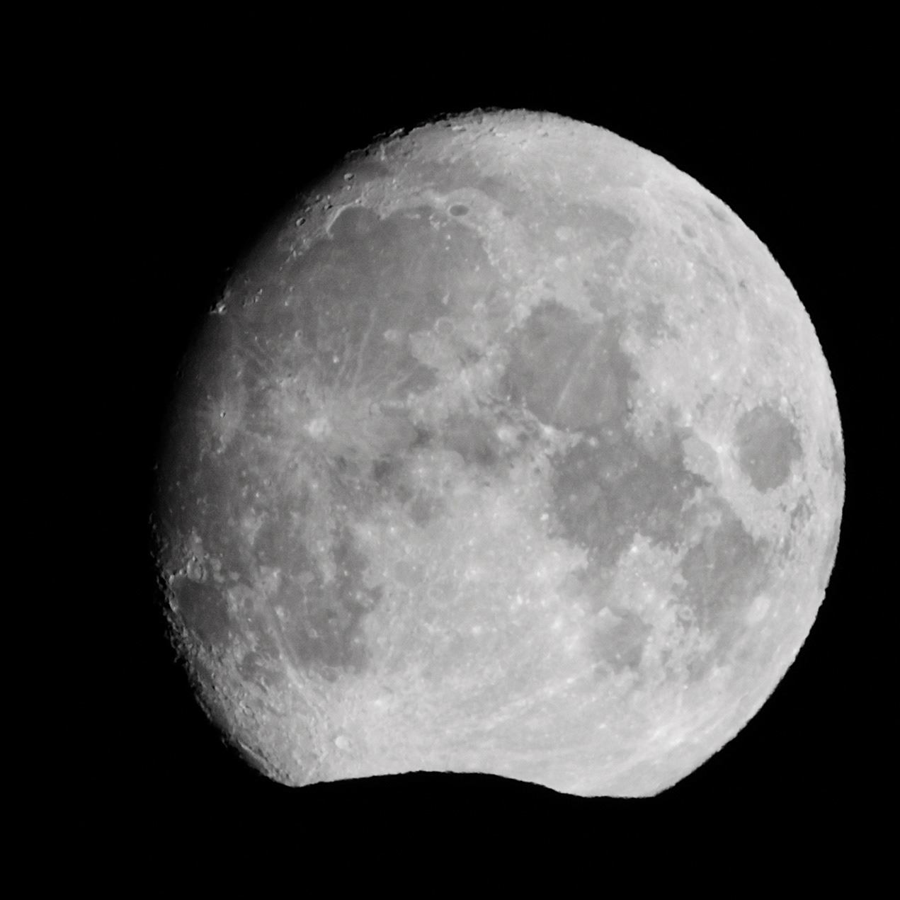 Nearly full moon, touching the mountains