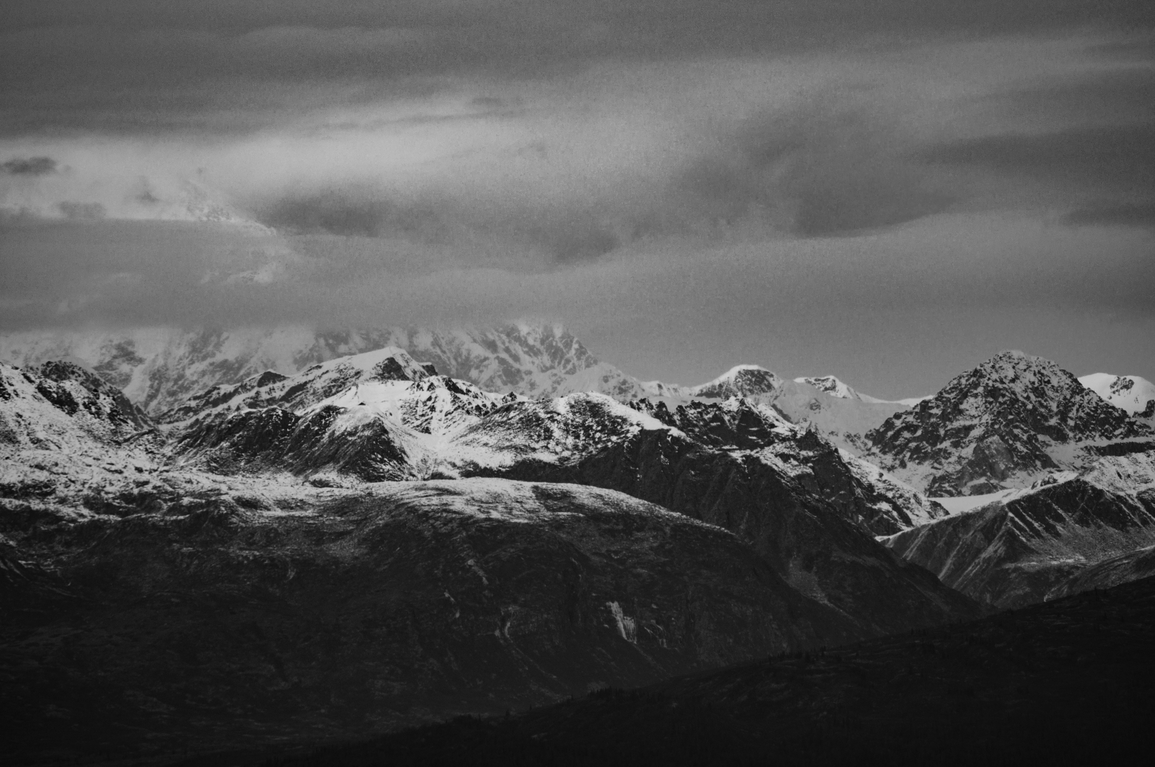 black and white mountains with clouds