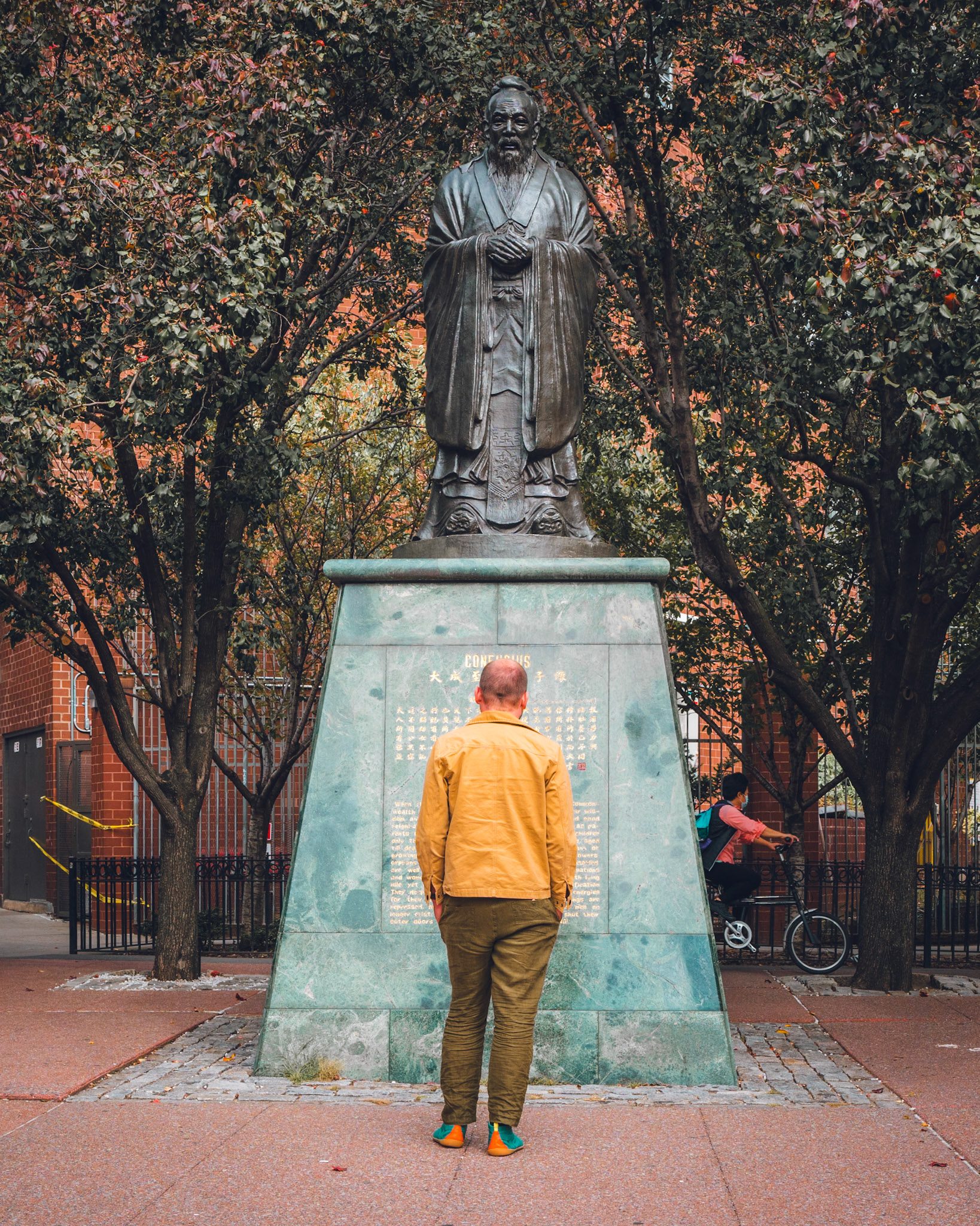 Confucious and man in a yellow jacket.