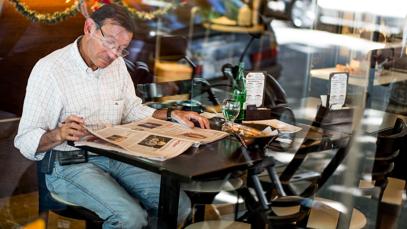 Man reading the paper. Buenos Aires, Argentina.