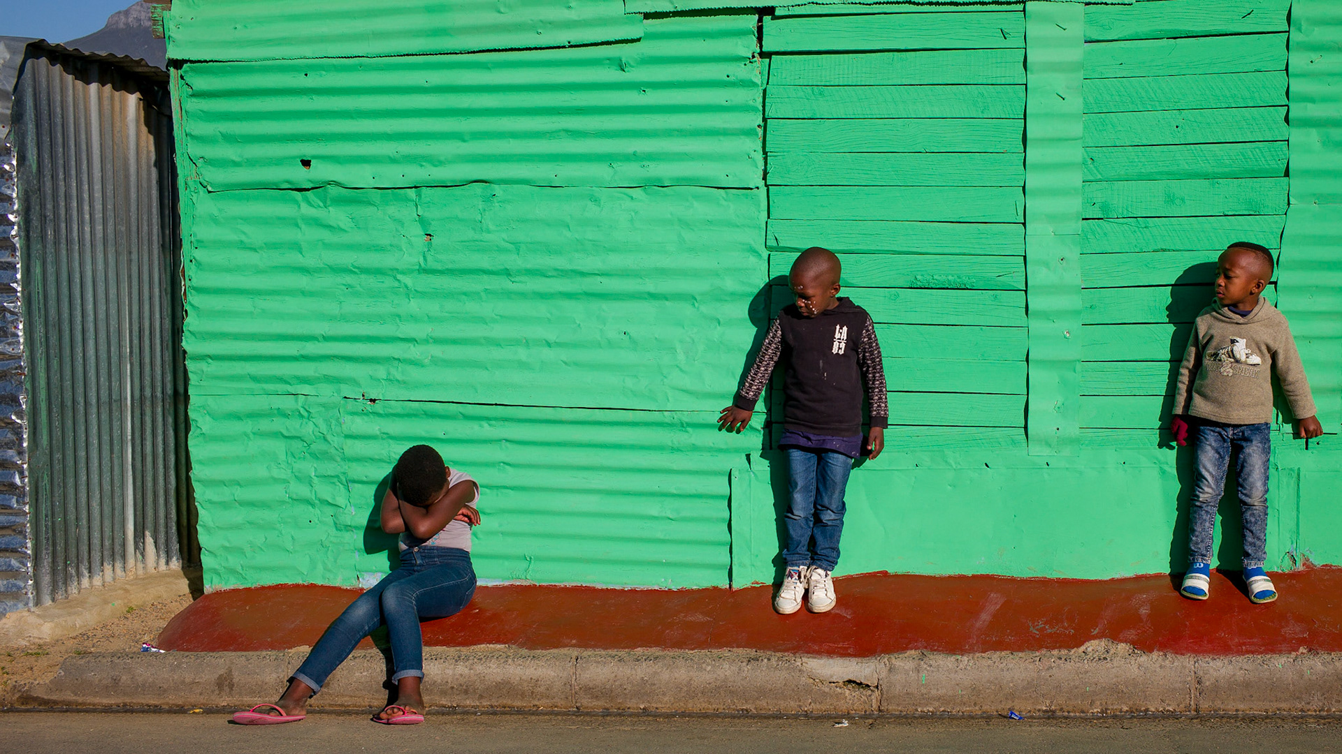 Three children outside Cape Town, South Africa. The girl was shy and didn't want her photo taken.