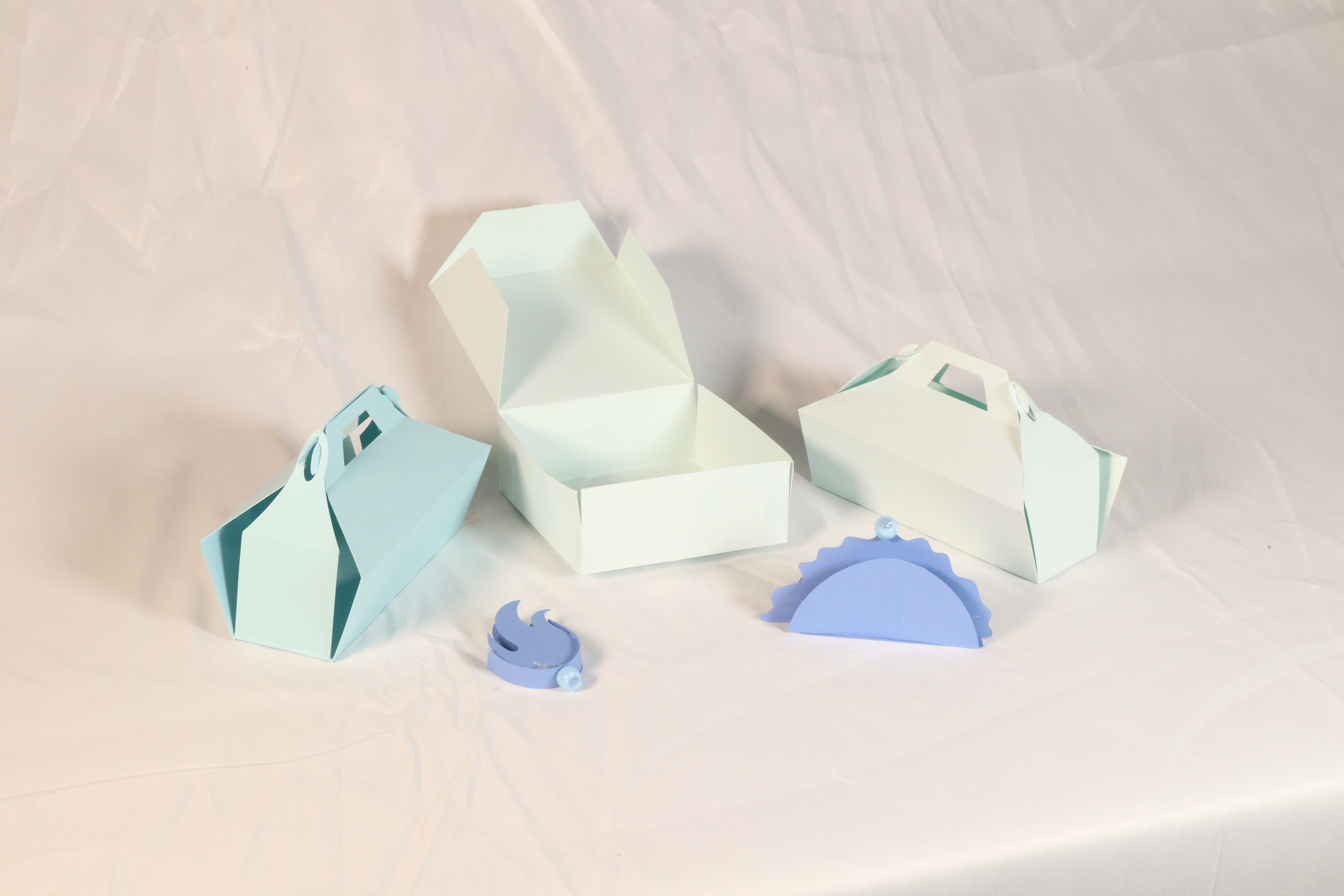 3 paper box prototypes, and 2 paper mockups of a sauce container