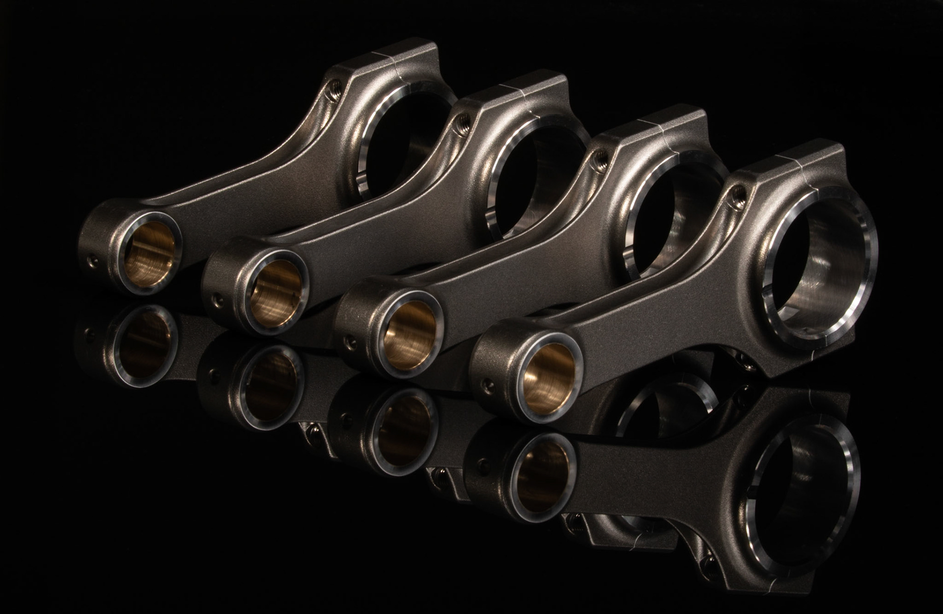 engine parts from a racing motorcycle on a black reflective background