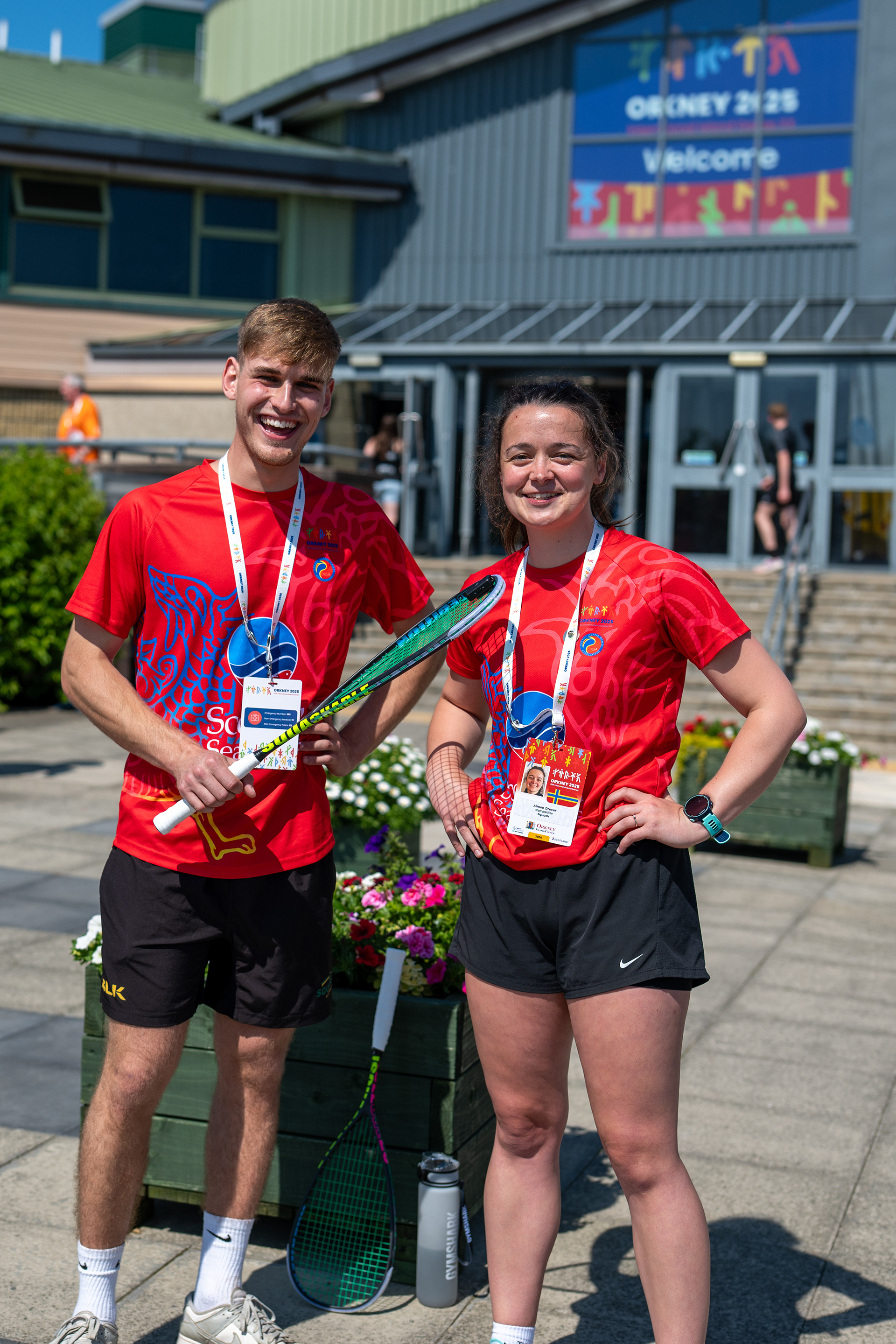 Young athletes taking a picture outside a branded venue façade Orkney 2025 at Pickaquoy Centre, Kirkwall, Orkney, Scotland 