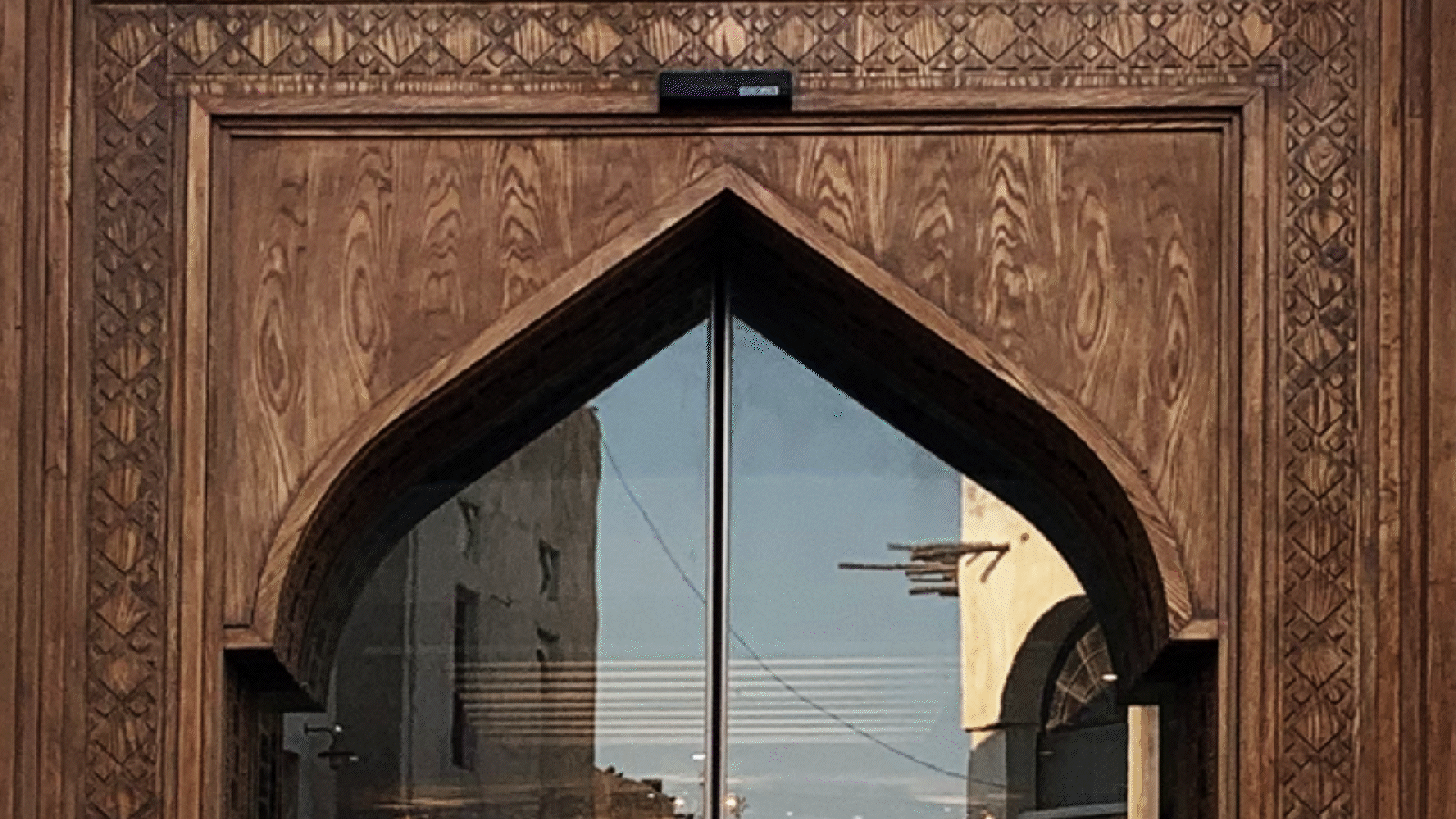 Animated graphic showing the construction of the "Open Doors" design element, inspired by traditional Arab archways. The animation reveals how the shape evolves into a modular connector used for cohesive stadium dressing and visual branding