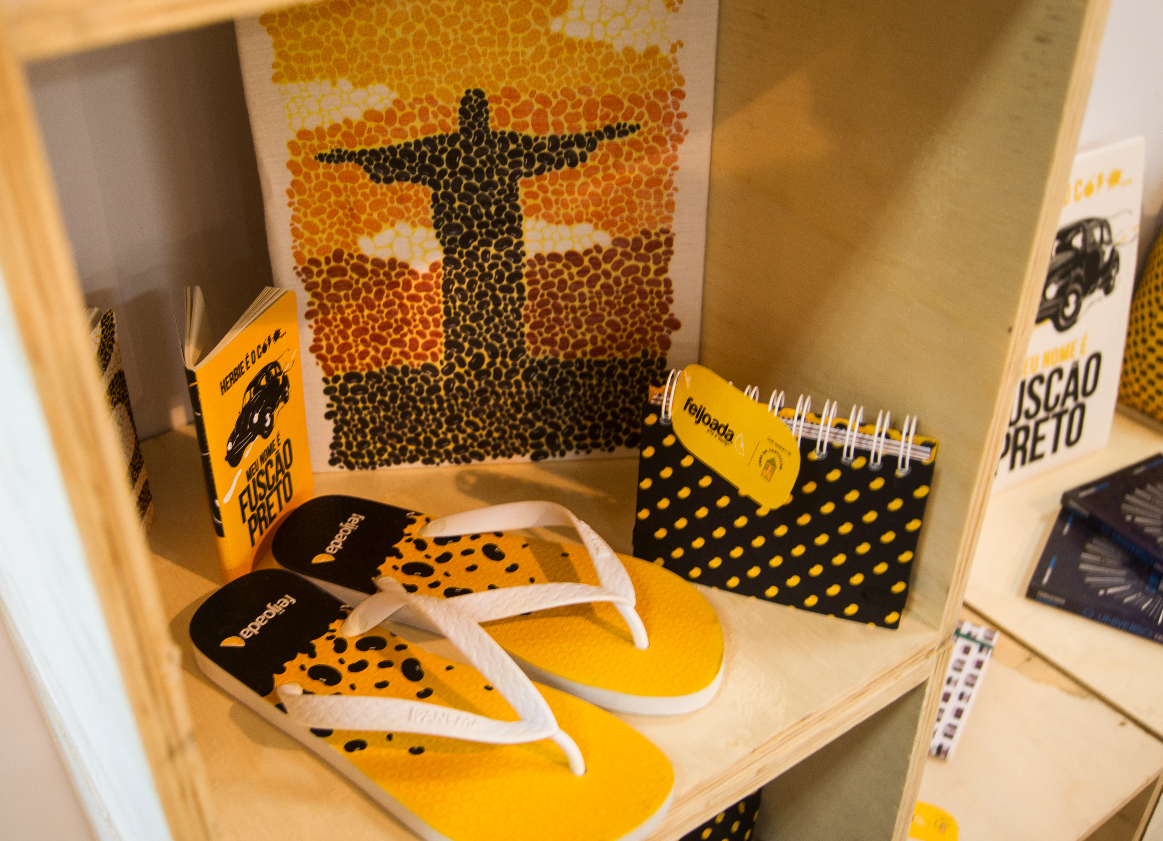 Products from Feijoada Art & Design on display at Parallel Gift Fair in São Paulo featuring bold typography and Brazilian market colours, illustrating feijoada cultural motifs