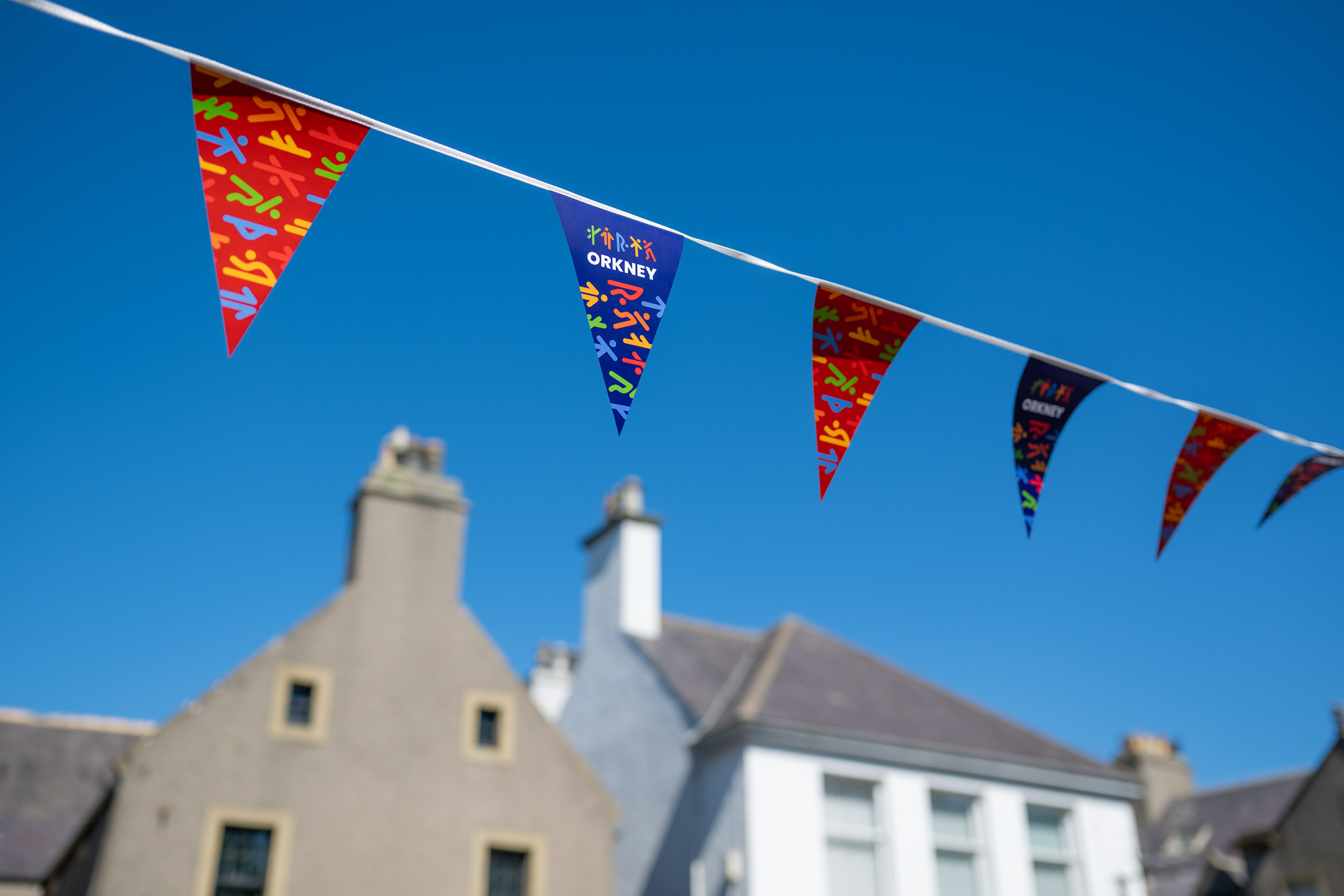 Orkney streets decorated with Island Games Orkney2025 bunting and flags.