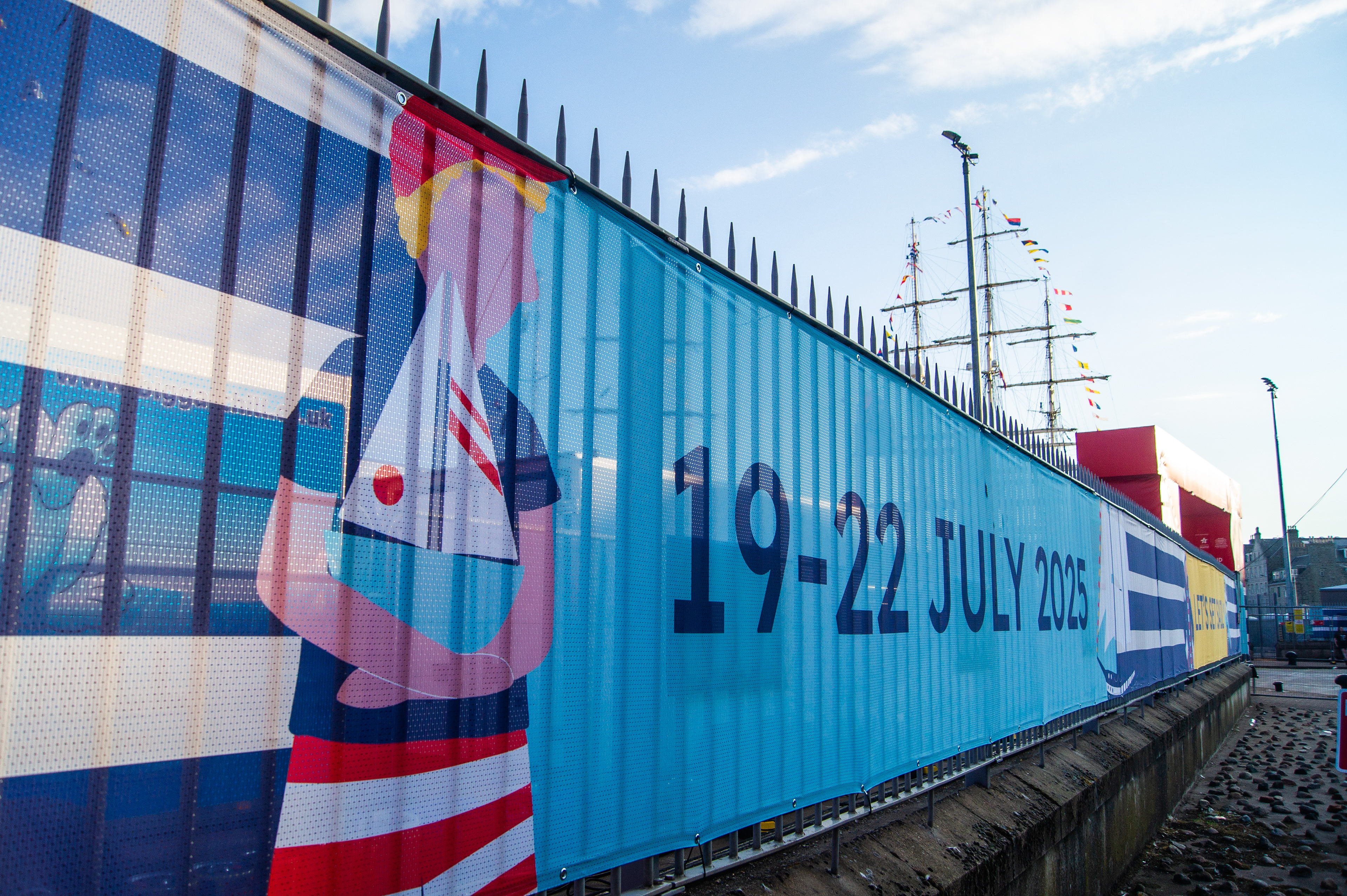 Festival-wide branding for the Tall Ships Race Aberdeen 2025 with venue dressing, stage graphics, bunting, and city centre applications.
