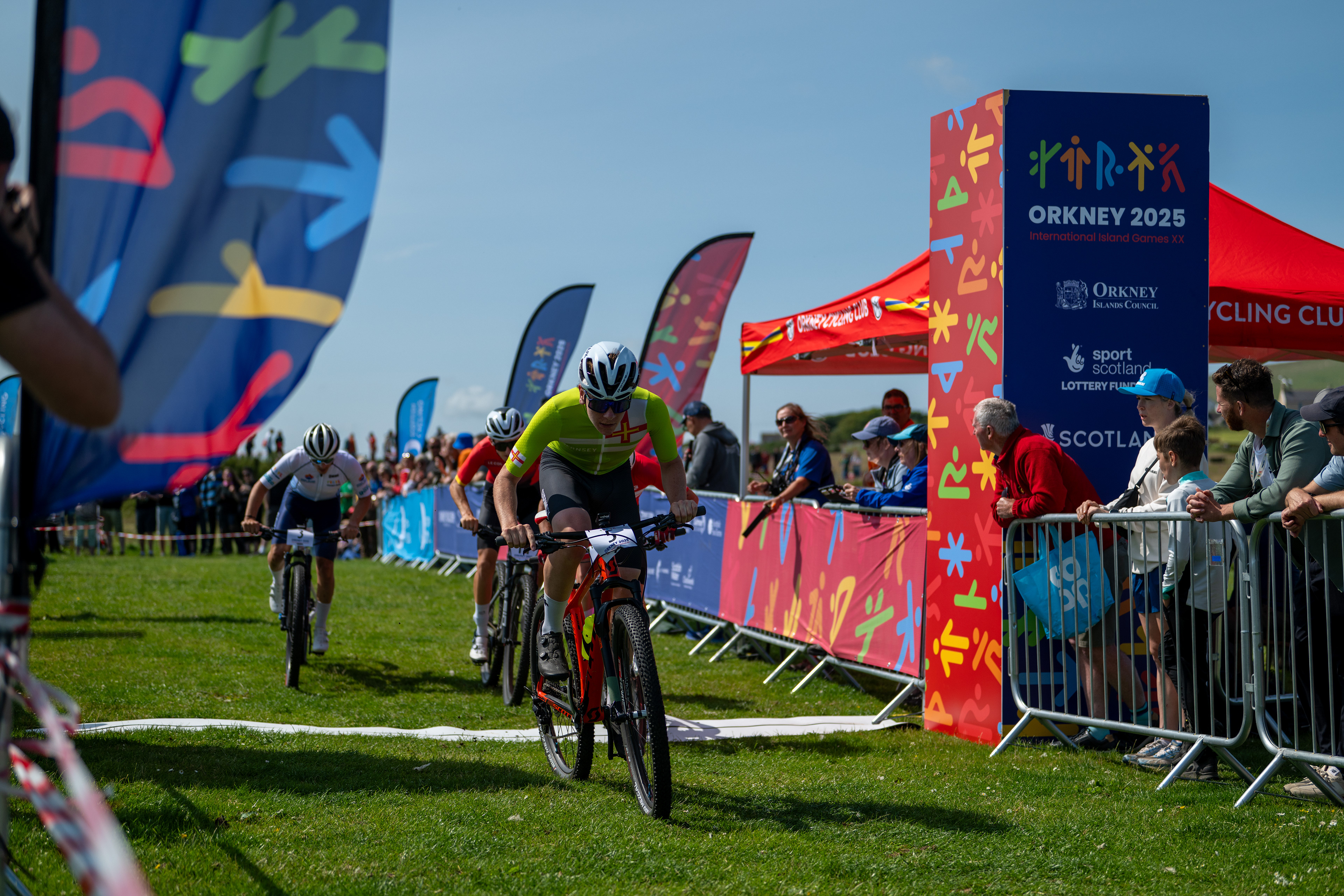 Mountain Biking arena dressed with Orkney 2025 event dressing  banners, towers and branding flags.