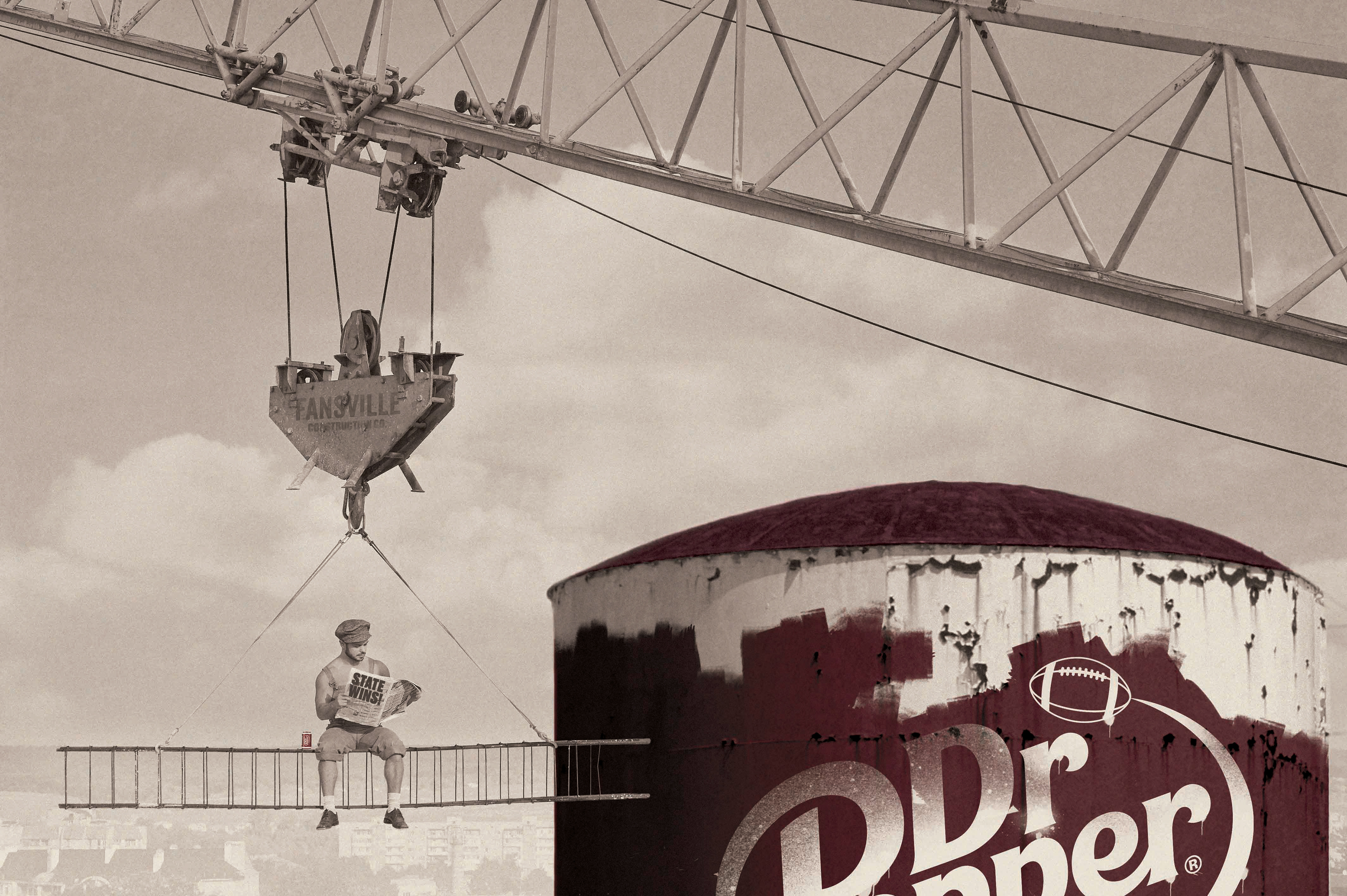 Excerpt from the timeline: A photograph showing a worker stop to read while constructing the famous Fansville tower.