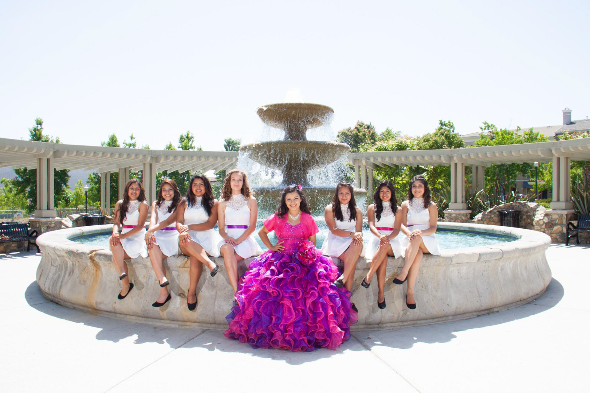 Quinceanera with damas sitting by the fountain at Elfin Forest by Paloma Jacobo Photography.