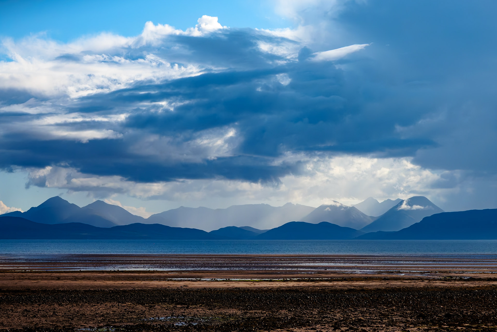 Rainswept Cuillin Mountains on Skye seen across Applecross Bay.