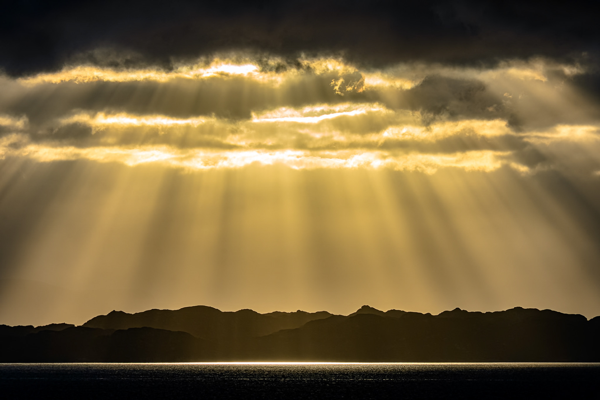 Golden rays of sunlight illuminating the isle of Raasay, west coast of Scotland.