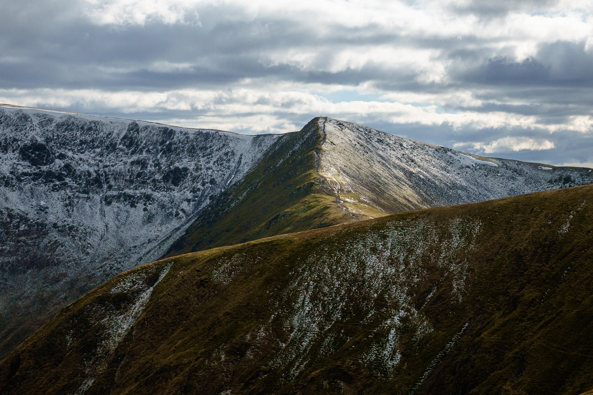 Colour shot of snow capped ridges in the high Lakeland fells, Cumbria.