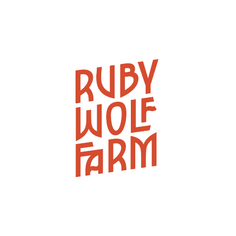 Logo that reads as Ruby Wolf Farm in red text on a white background, it has a fairytale-like look