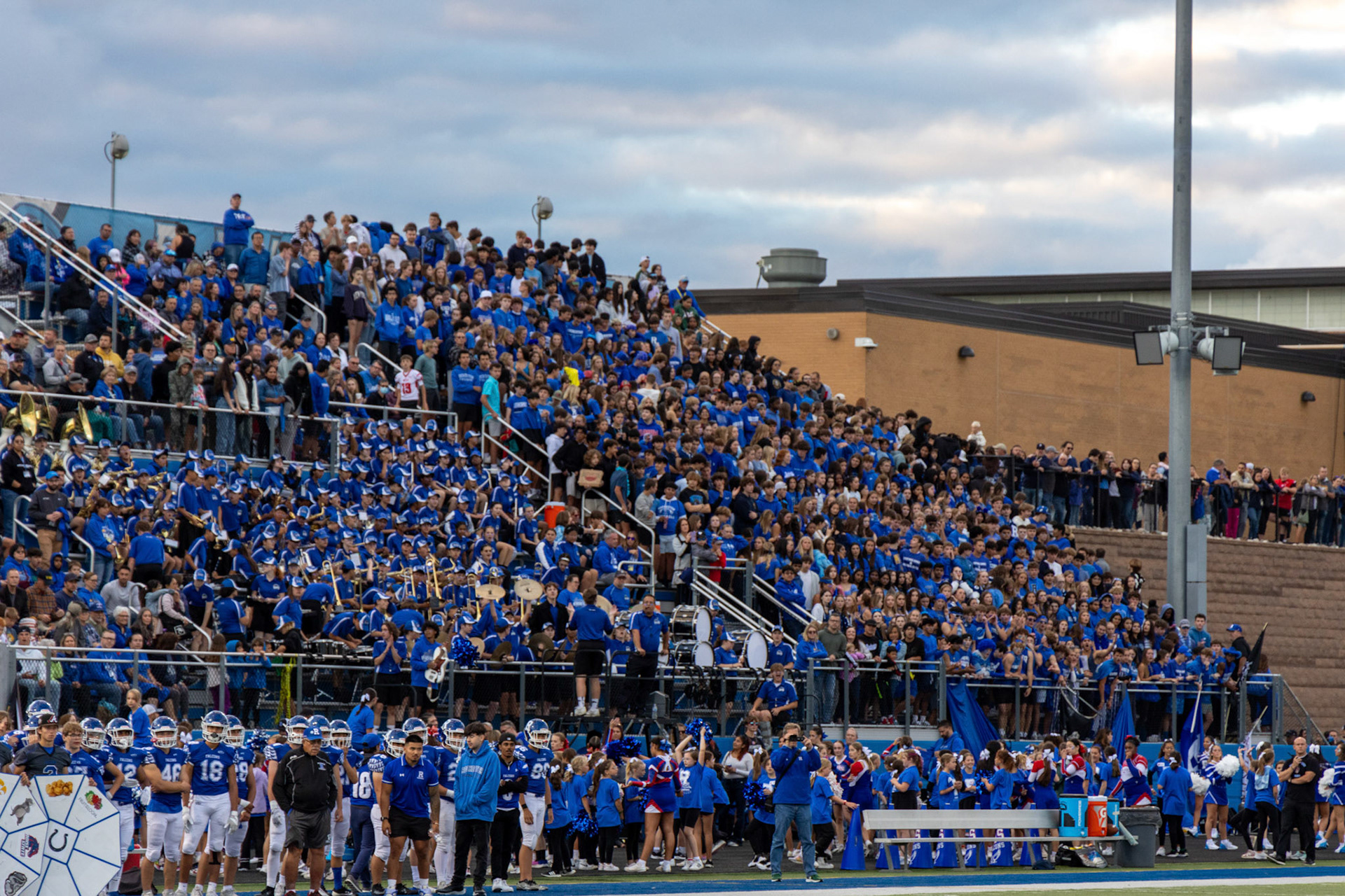 Wanted to show the true scale of these home football games (which is why the image is focused on one signular person on the sideline to show a comparison of scale to the massive crowd of blue in the back)