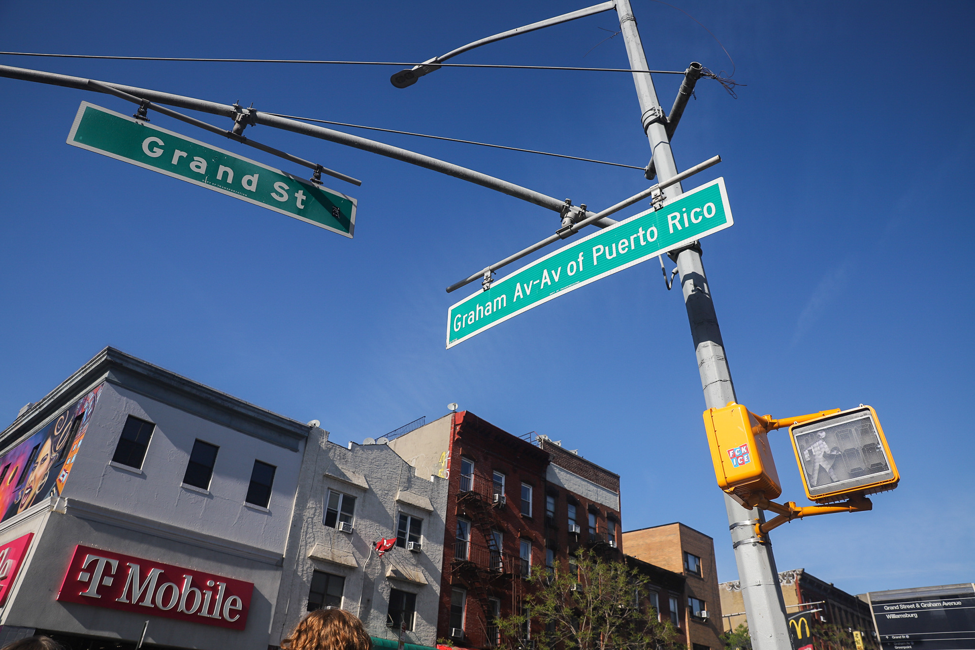 Across the street from the mural is Ave of Puerto Rico, alongside Graham Ave and Grand St. Puerto Ricans have settled in this neighborhood since the 1920s. Despite an attempt to remove the sign, it was quickly put back in 2023. April 18, 2026