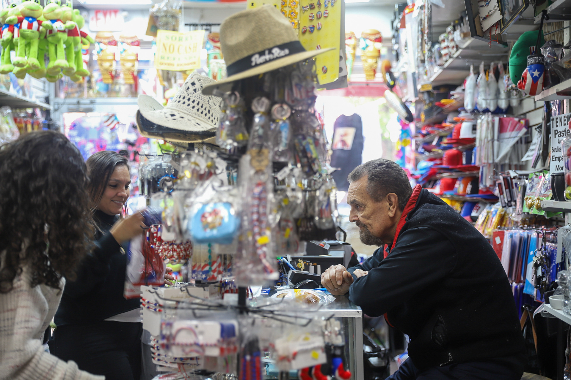 The owner, Radames Millan, interacting with two customers. May 1, 2026