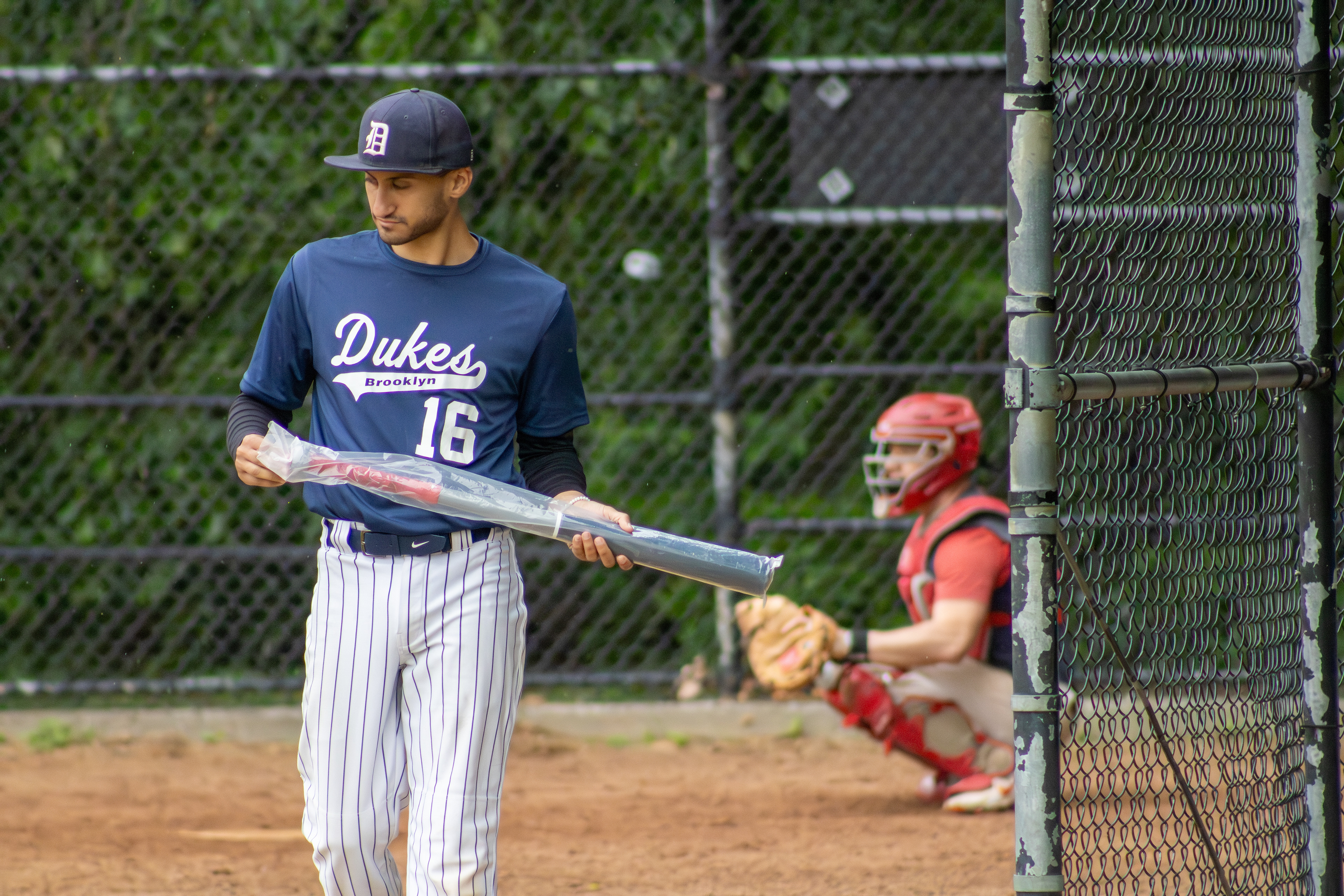 Eric Pascale unwraps a new baseball bat.