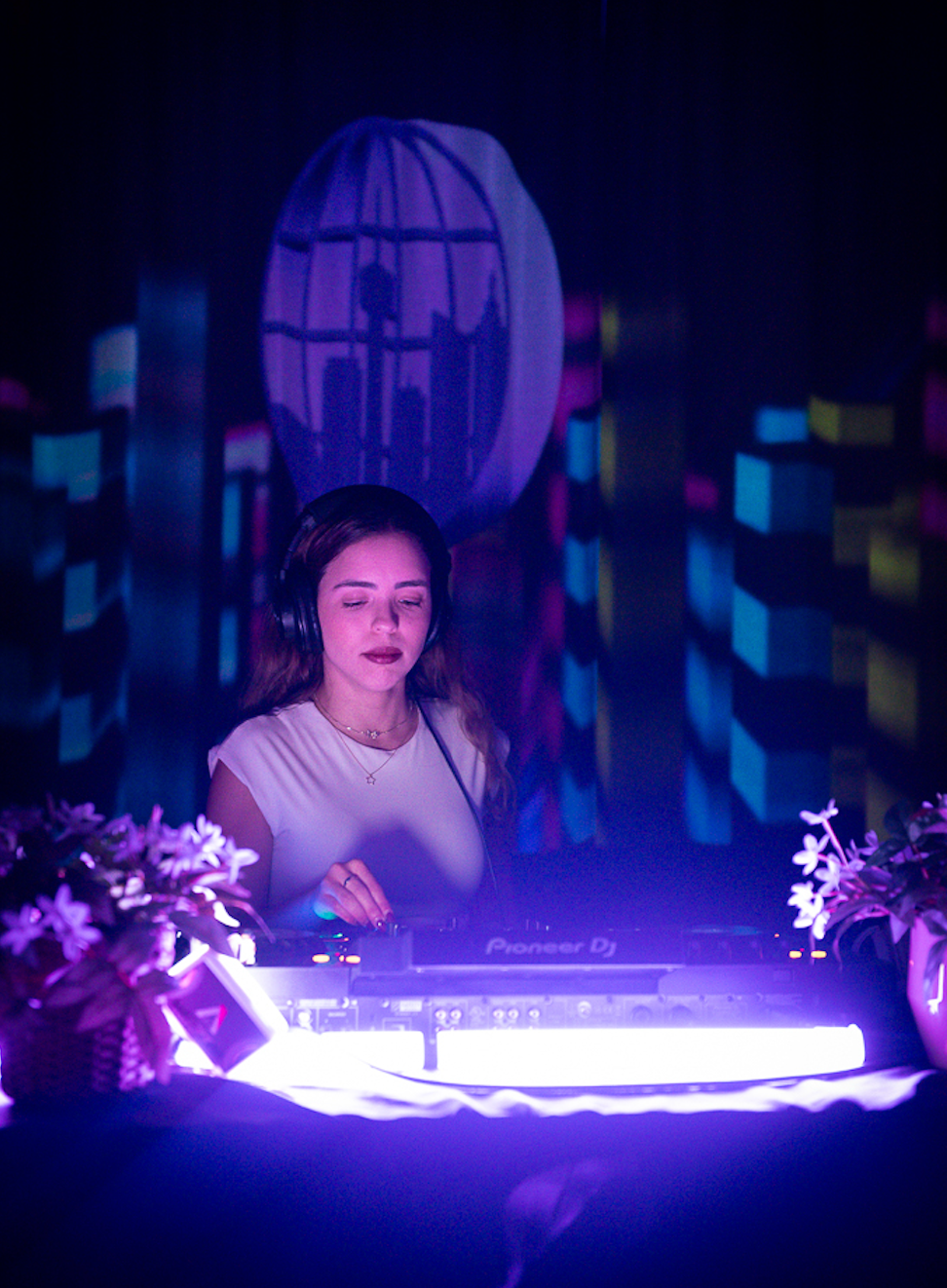 Caption: DJ Larisa cues up her next track behind the mixing board during a live performance at Bar Dem in Toronto on Thursday, Jan. 29, 2026. The local artist provided an upbeat soundtrack for patrons enjoying a fun night out at the venue. Camera Settings: 1/100, ISO 6400, f/2.8
