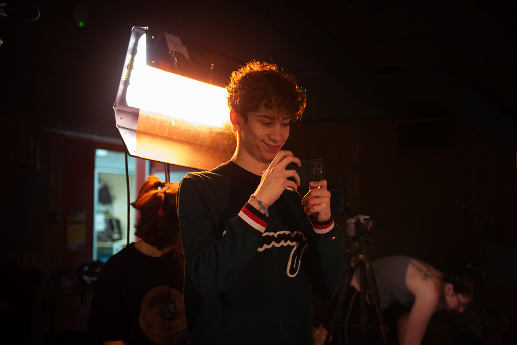 Caption: Third-year, Media production student Lucas Calinsky adjusts a small behind-the-scenes camera mounted on a stand in Studio B during a Met TV production in Toronto in February 2026. He was helping set up for the student-run show called "Study Break," where he is one of the actors. Camera Settings: 1/60, ISO 800, f/4.0