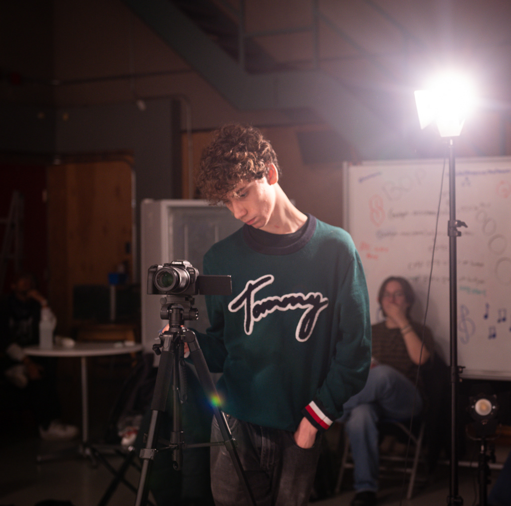 Caption: Third-year, Media production student Lucas Calinsky looks focused while preparing Studio B for a taping of the Met TV show "Study Break" in Toronto in February 2026. The third-year student and cast actor was assisting crew members by setting up the actors. Camera Settings: 1/60, ISO 2000, f/2.8